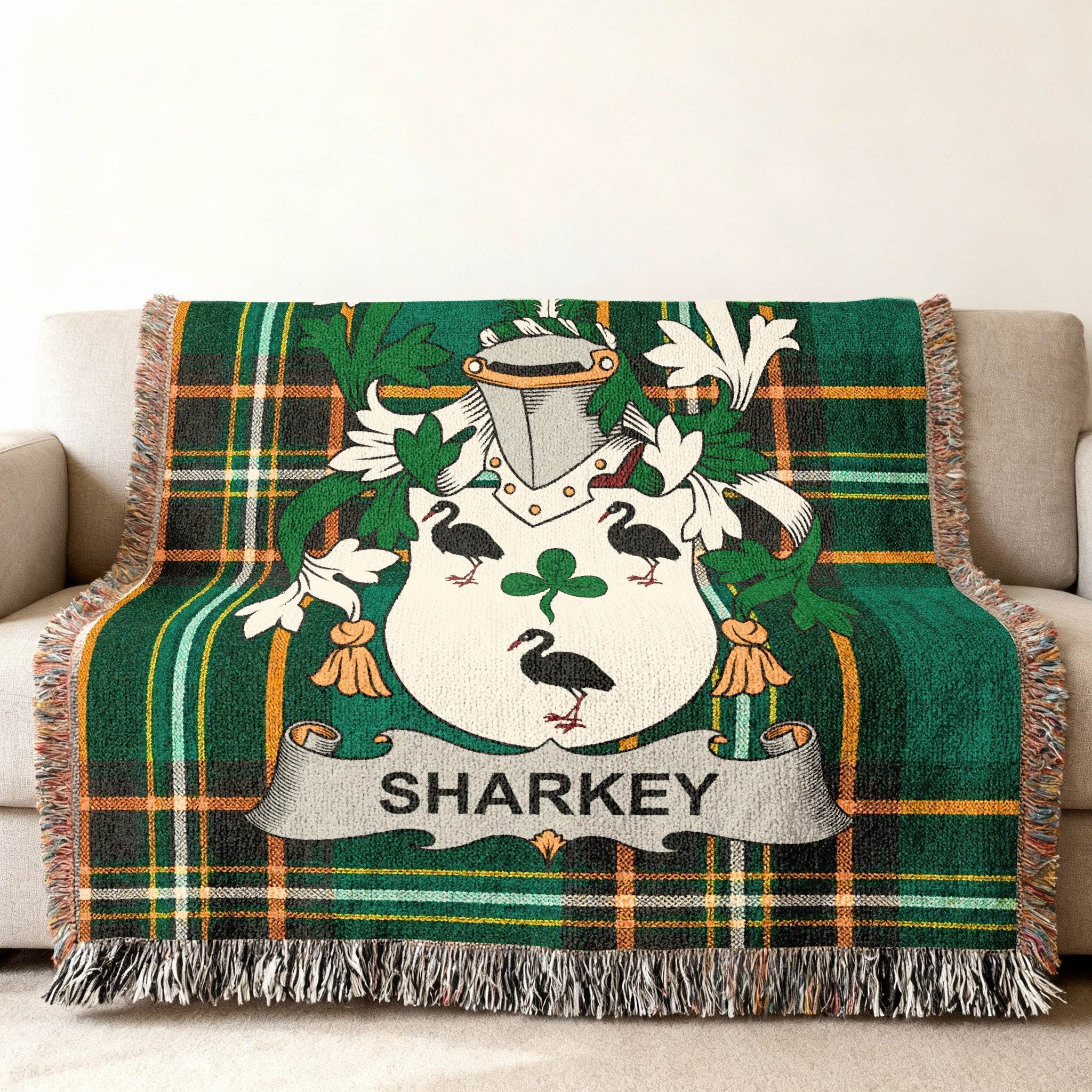 Sharkey family crest on a green plaid woven blanket draped over a sofa.