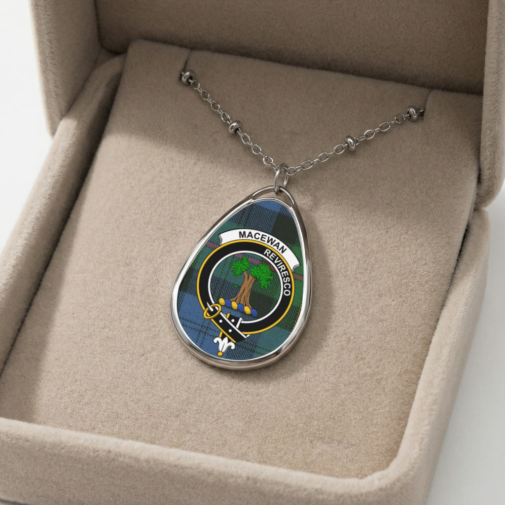Oval pendant necklace with MacEwan clan crest on tartan in a jewelry box.
