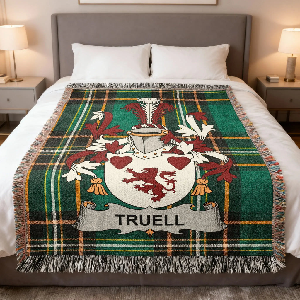 Green tartan blanket with Truell family crest featuring a shield and two lions.