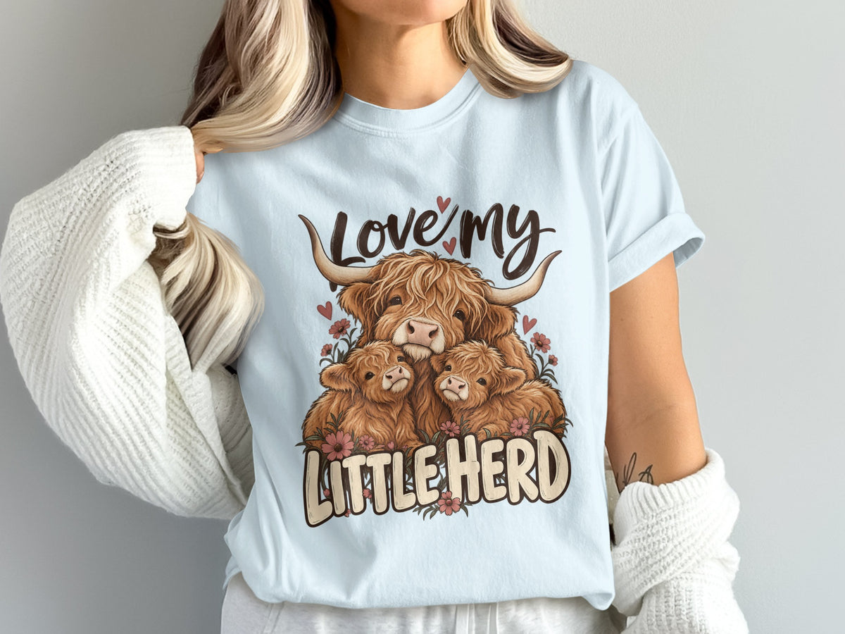Model wearing the Love My Little Herd Highland cow Comfort Colors T-shirt in Chambray