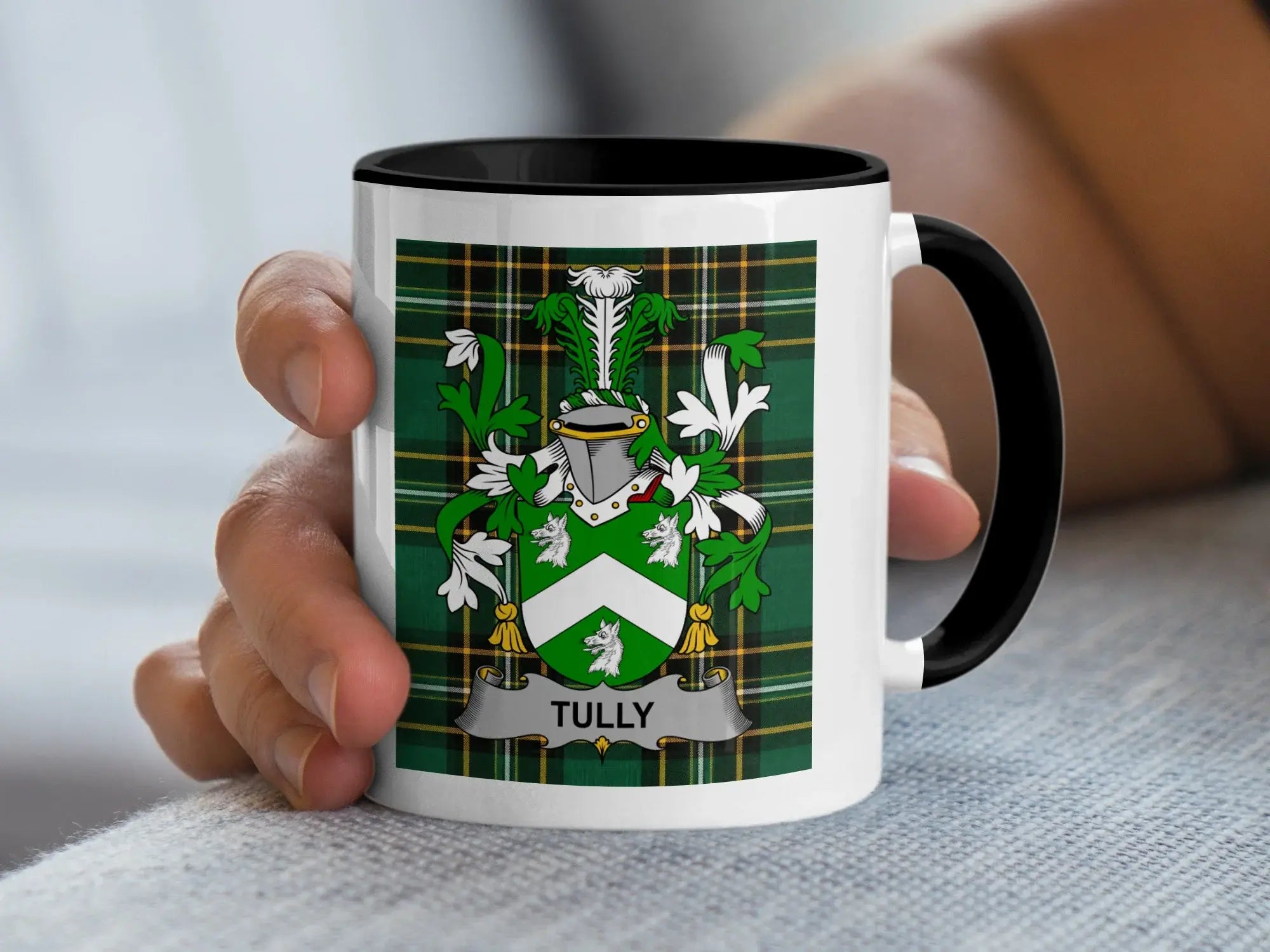 White mug with black rim featuring a green plaid design and a coat of arms with "Tully" banner.