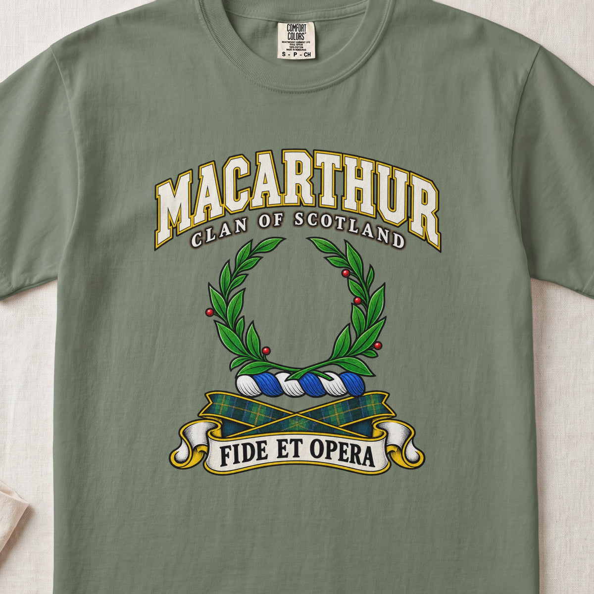 MacArthur Scottish clan T-shirt in Moss, front view with a green laurel wreath and motto design.