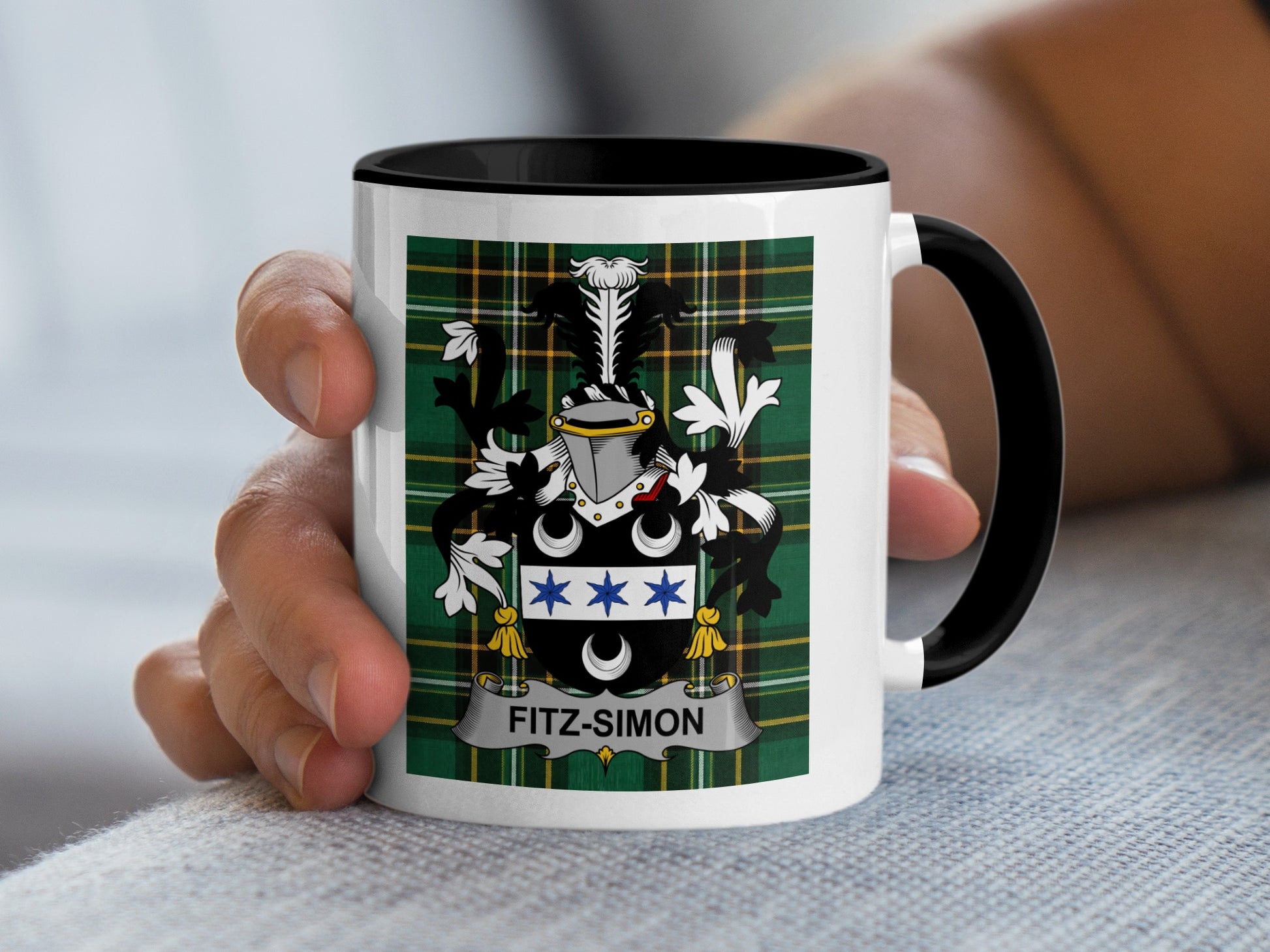 White mug with black rim featuring Fitz-Simon family crest on plaid background.