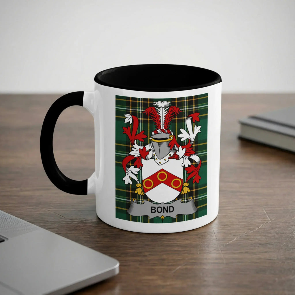 White mug with black rim featuring a green plaid pattern and the Bond family crest.