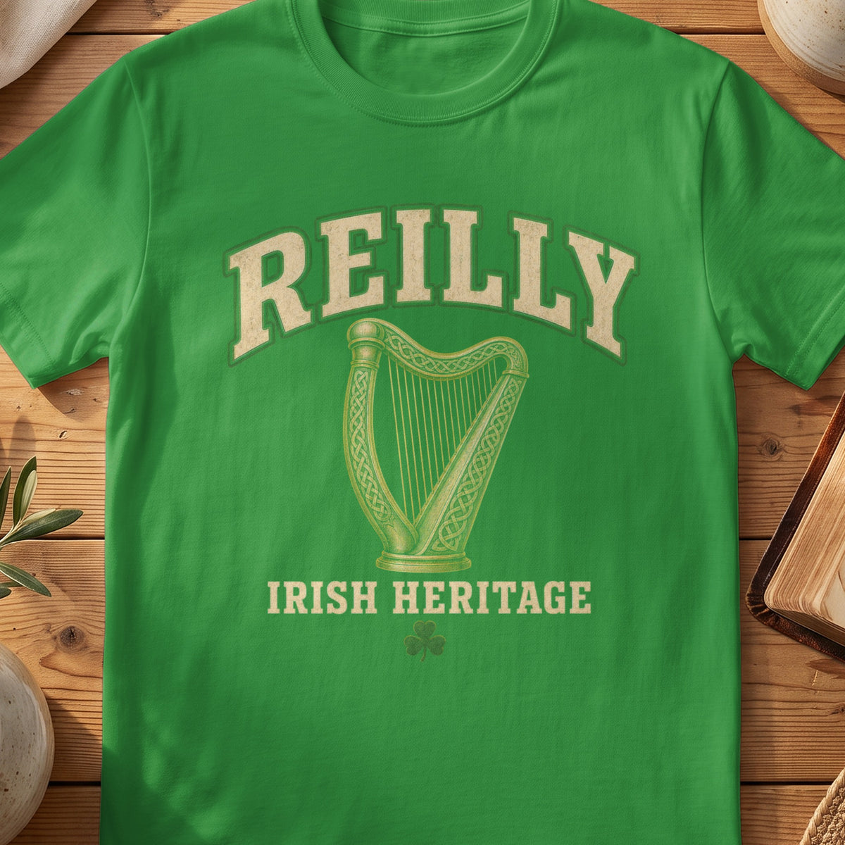 Reilly Irish harp T-shirt in Irish Green, with cream surname lettering, a gold-toned harp, green shamrock and “Irish Heritage” text.