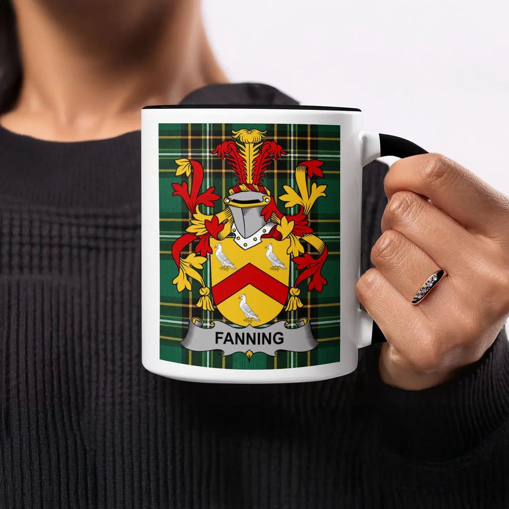 White mug with Fanning family crest on tartan background.