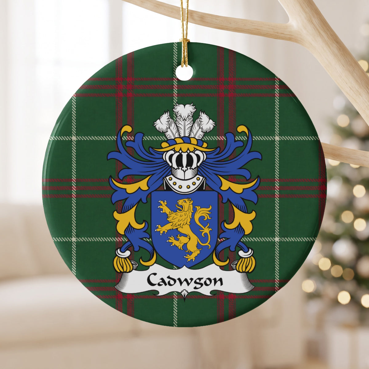 Cadwgon Style 2 ornament hanging from a pale wooden branch; a gold upright lion on a blue shield on Welsh national tartan.