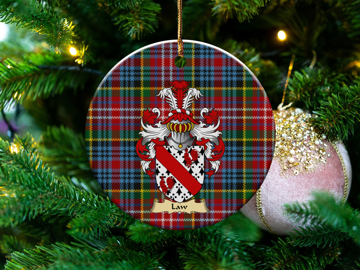 Law Scottish clan ceramic ornament with family crest on a Caledonia tartan background, hanging on a Christmas tree