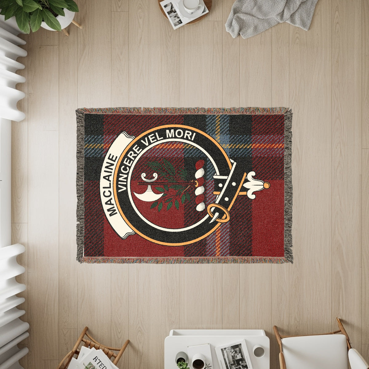 MacLaine of Lochbuie woven blanket displayed on a wall, featuring the crest badge and tartan background