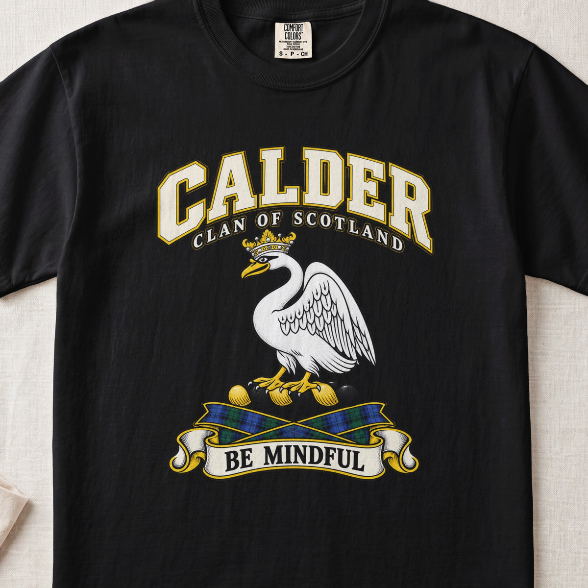 Calder Scottish clan T-shirt in Black, front view with a white swan wearing a gold crown and motto banner.