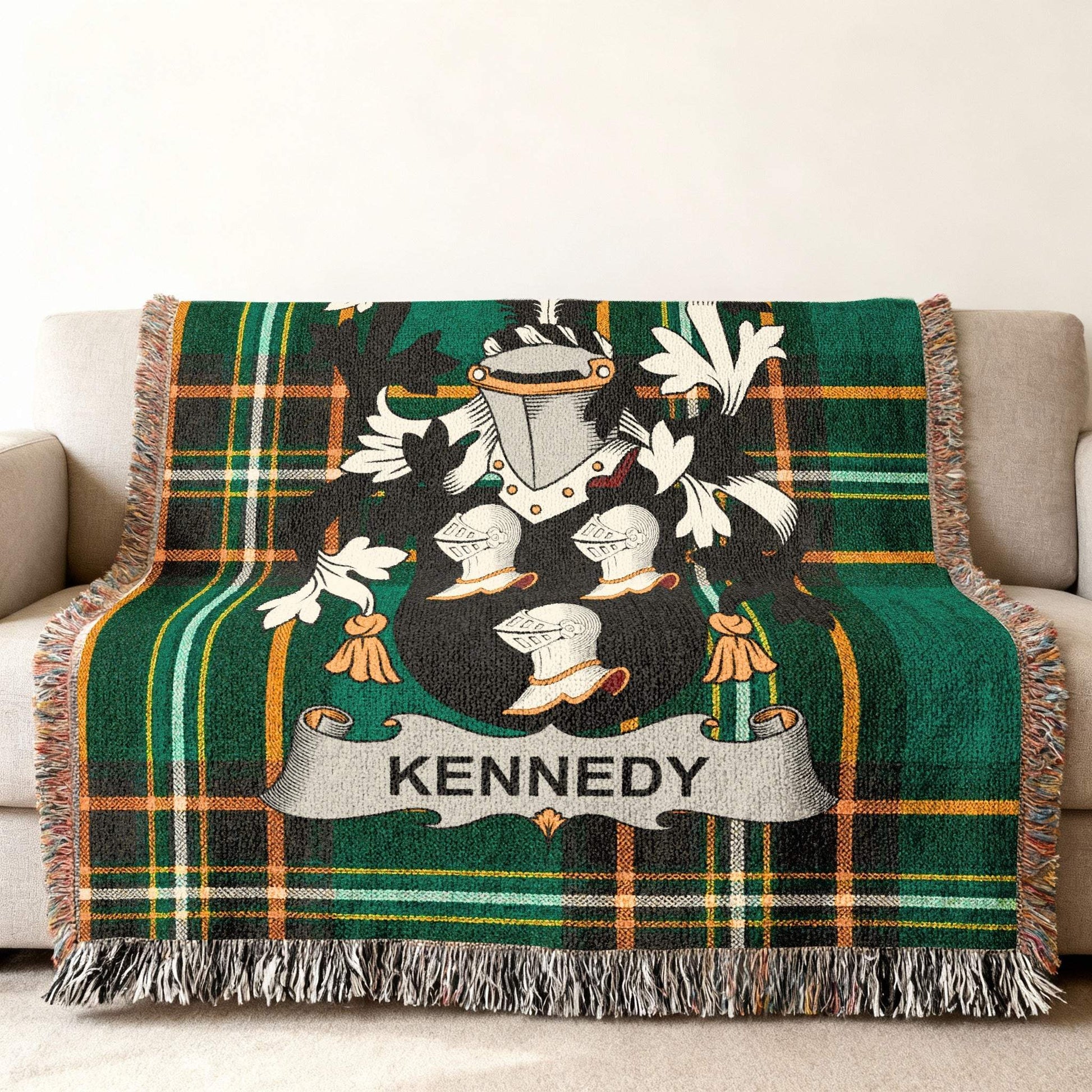 Woven blanket with green plaid and Kennedy family crest.