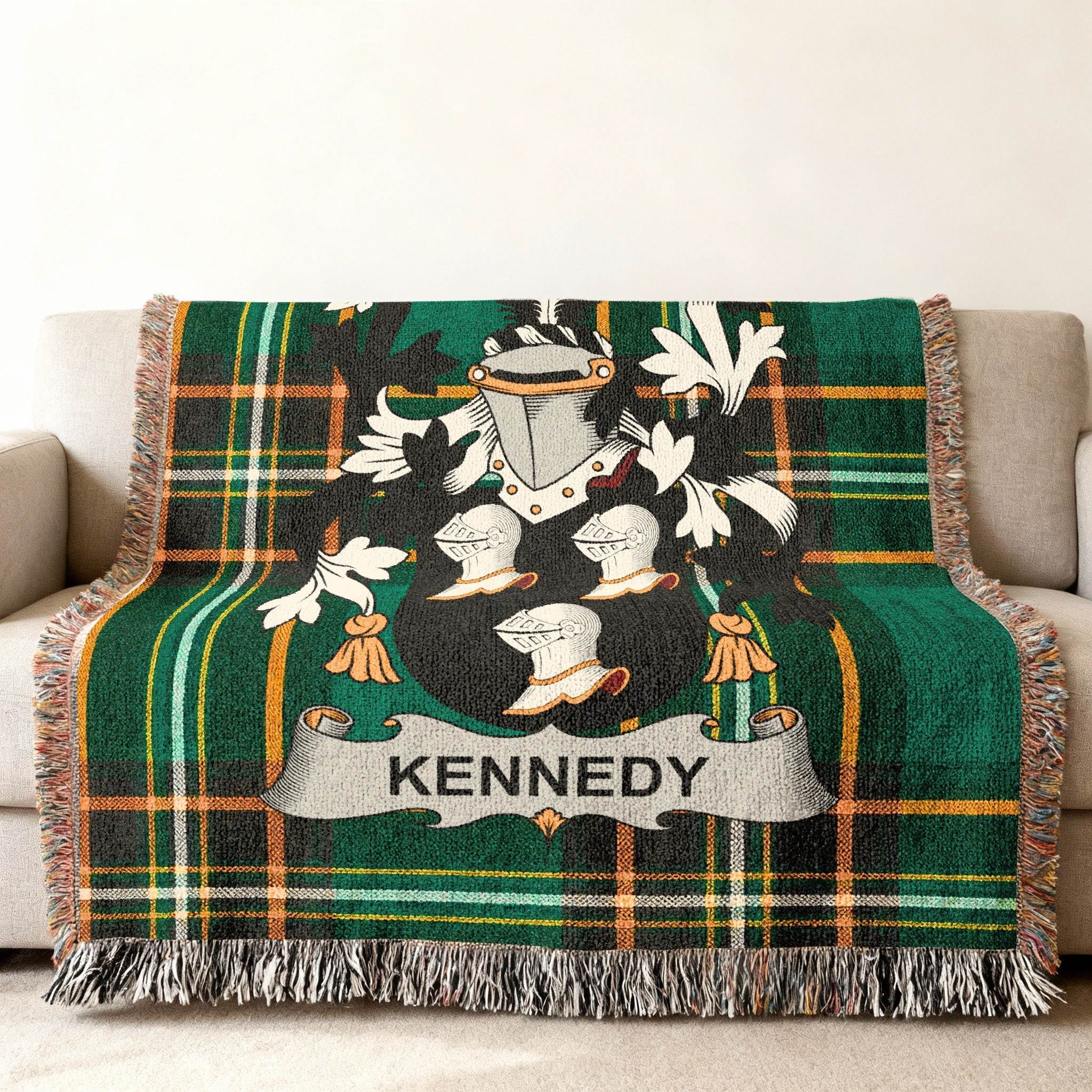 Woven blanket with green plaid and Kennedy family crest.