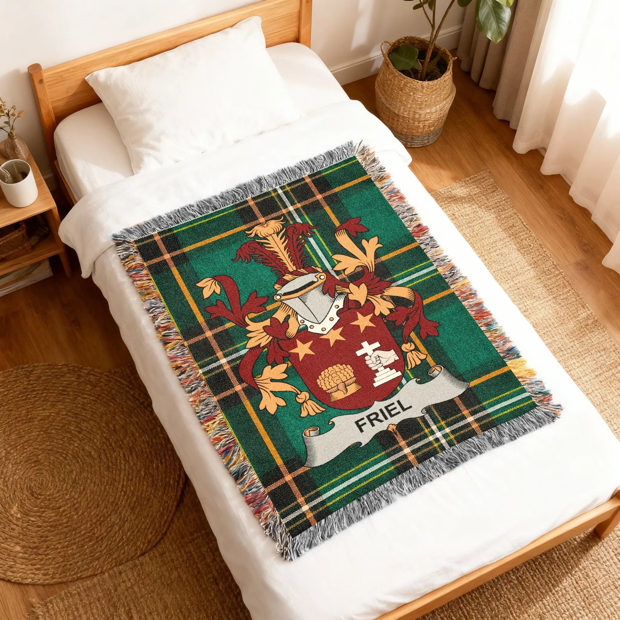 Green tartan blanket with the Friel coat of arms on a bed.