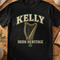 Kelly Irish harp T-shirt in Black, with cream surname lettering, a gold-toned harp, green shamrock and “Irish Heritage” text.