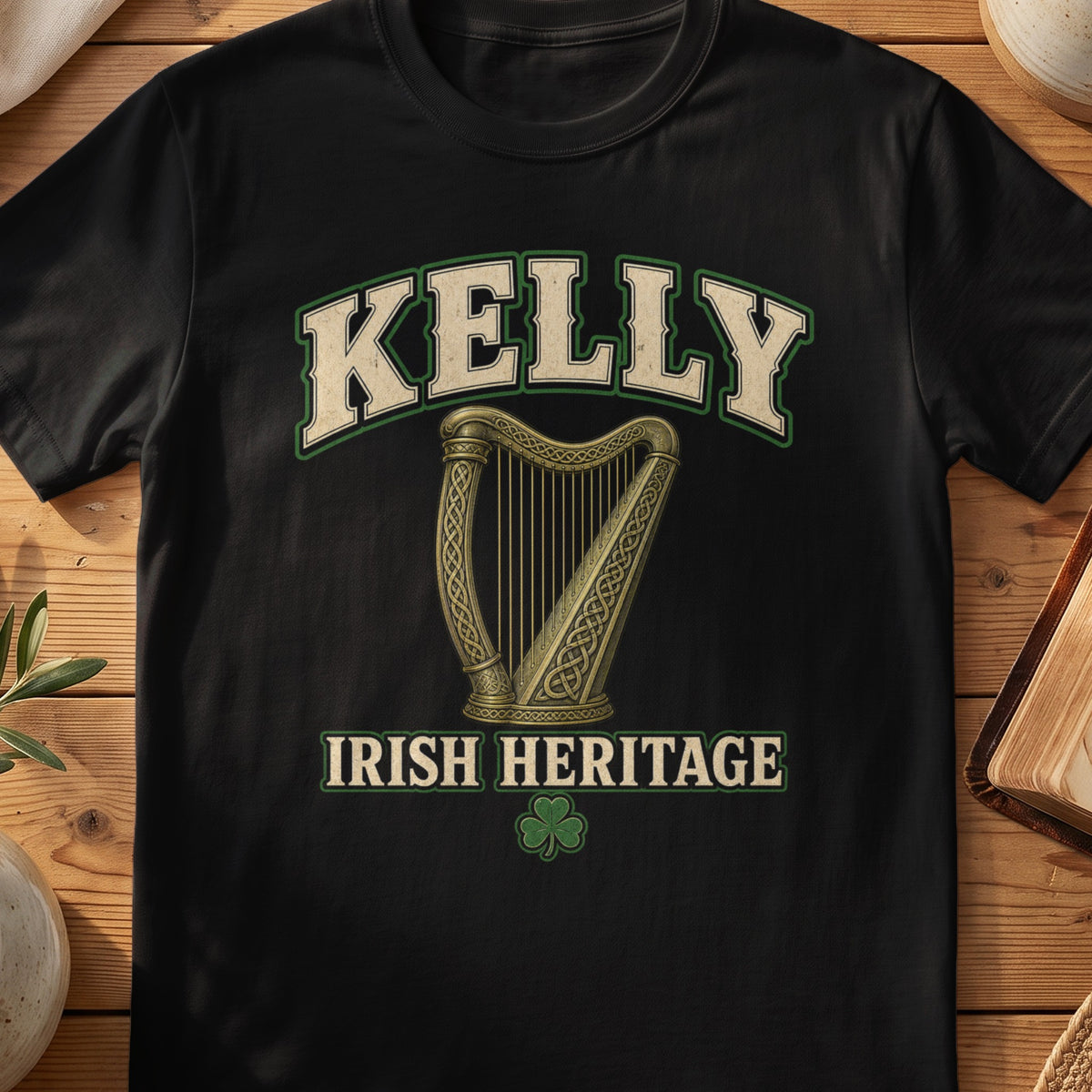 Kelly Irish harp T-shirt in Black, with cream surname lettering, a gold-toned harp, green shamrock and “Irish Heritage” text.