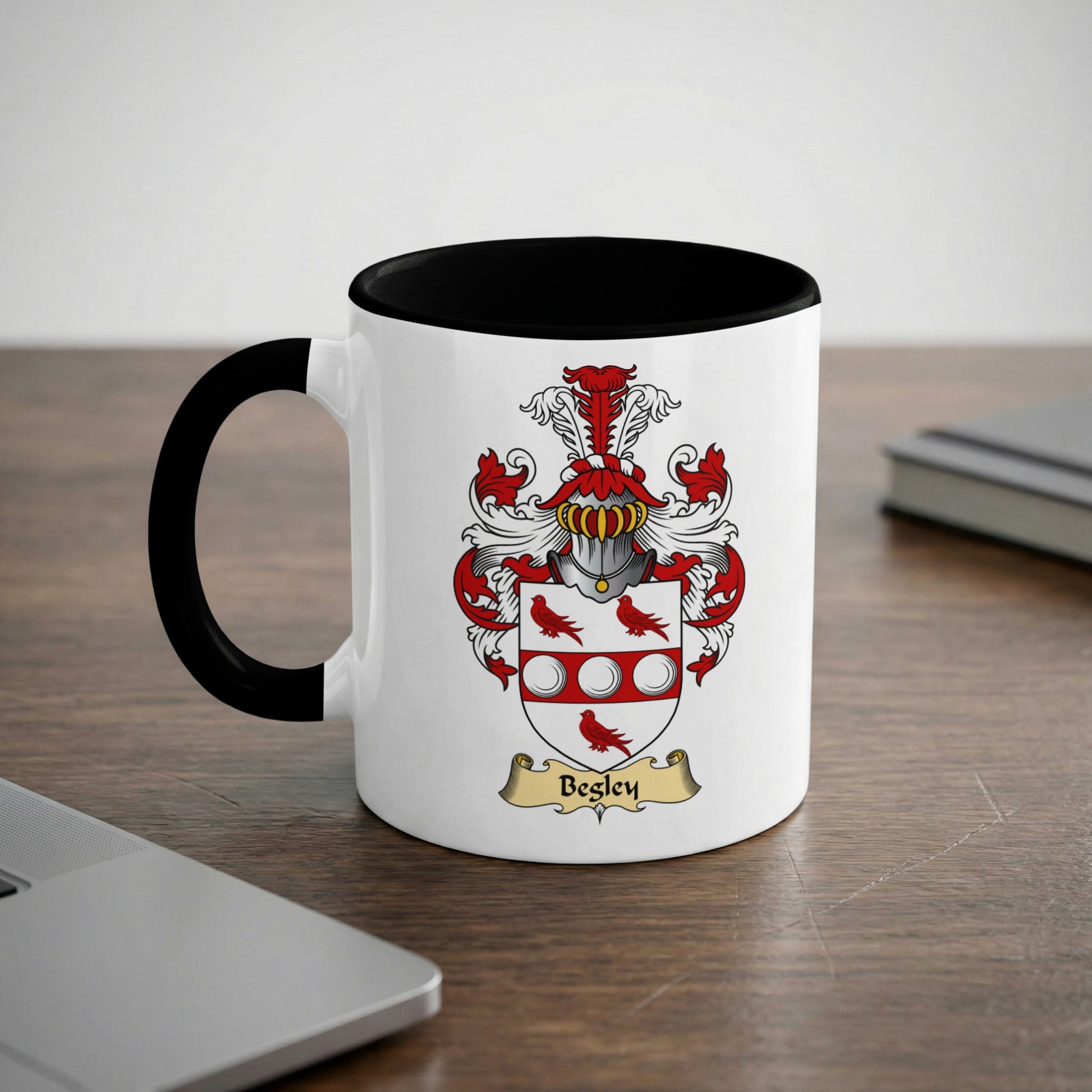 White mug with black rim featuring a coat of arms and "Begley" text.