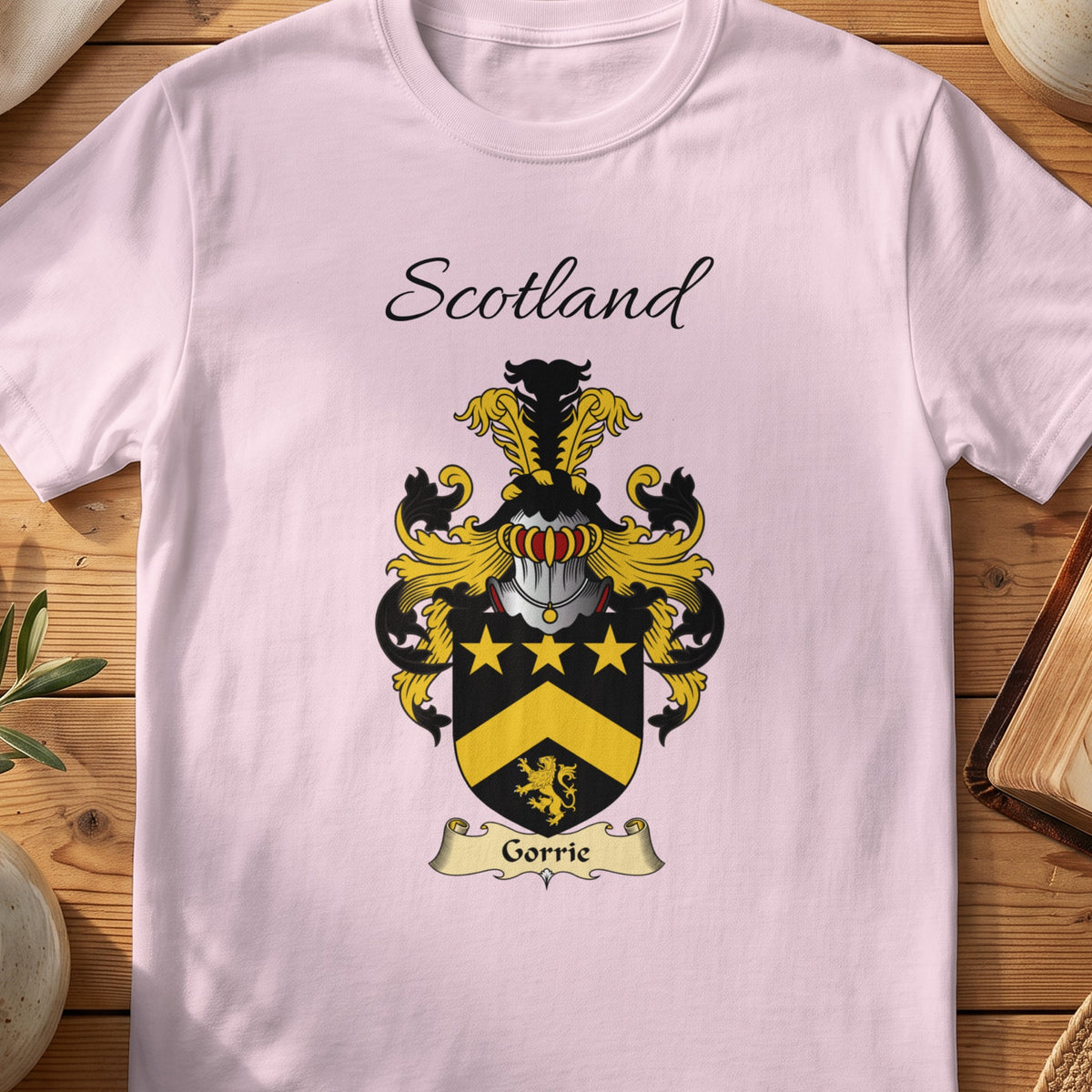 Light Pink Gorrie Scottish family shield T-shirt featuring gold stars and a gold chevron on black