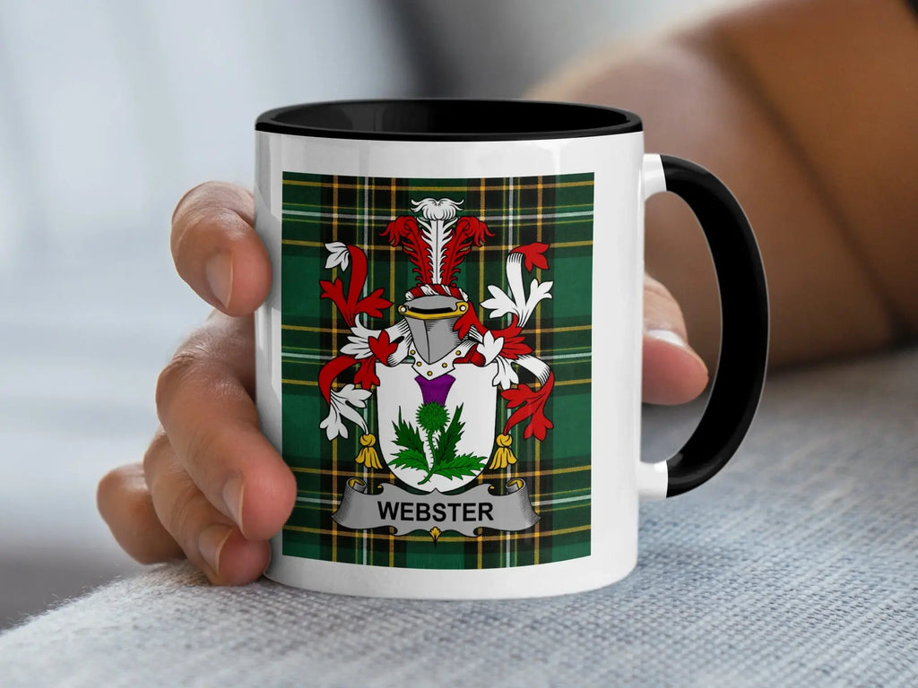 White mug with black rim featuring the Webster family crest on a tartan background.