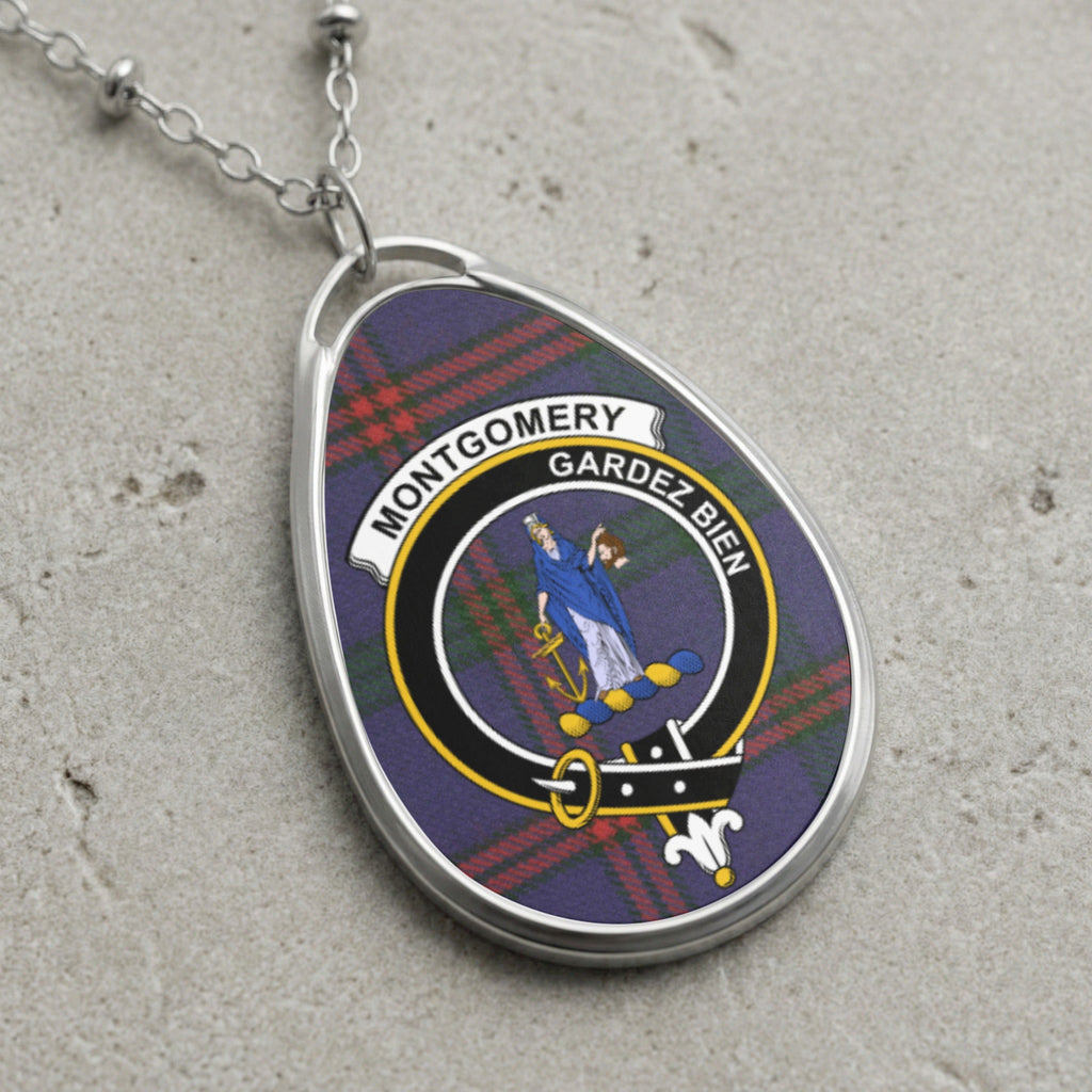 Montgomery Gardez Bien clan crest pendant necklace on tartan background.