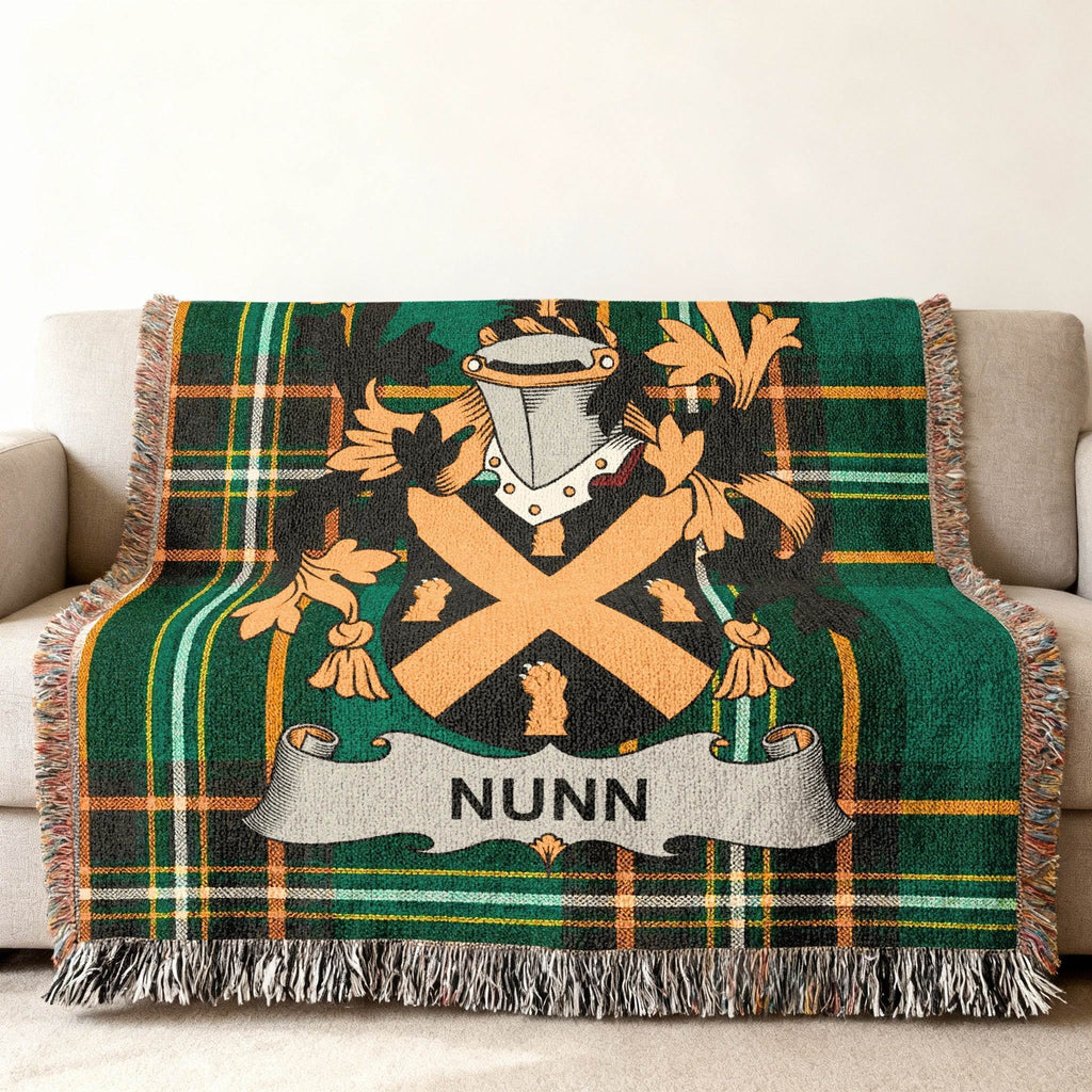 Nunn family crest on a green tartan plaid throw blanket.