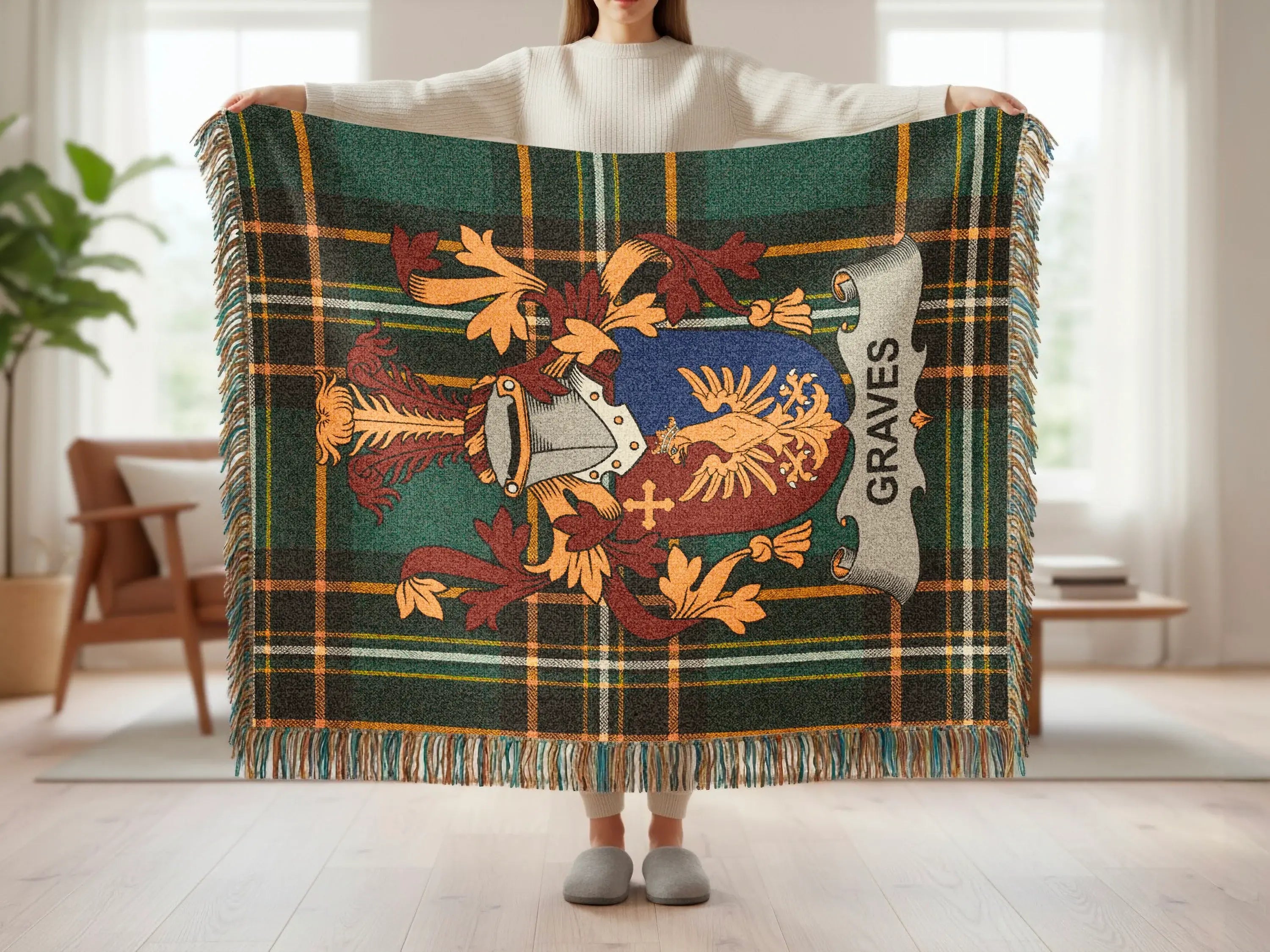 Tartan blanket with crest and "GRAVES" text, held by a person.