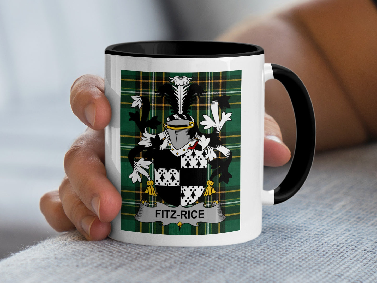 White mug with black rim featuring a Fitz-Rice family crest on a green plaid background.