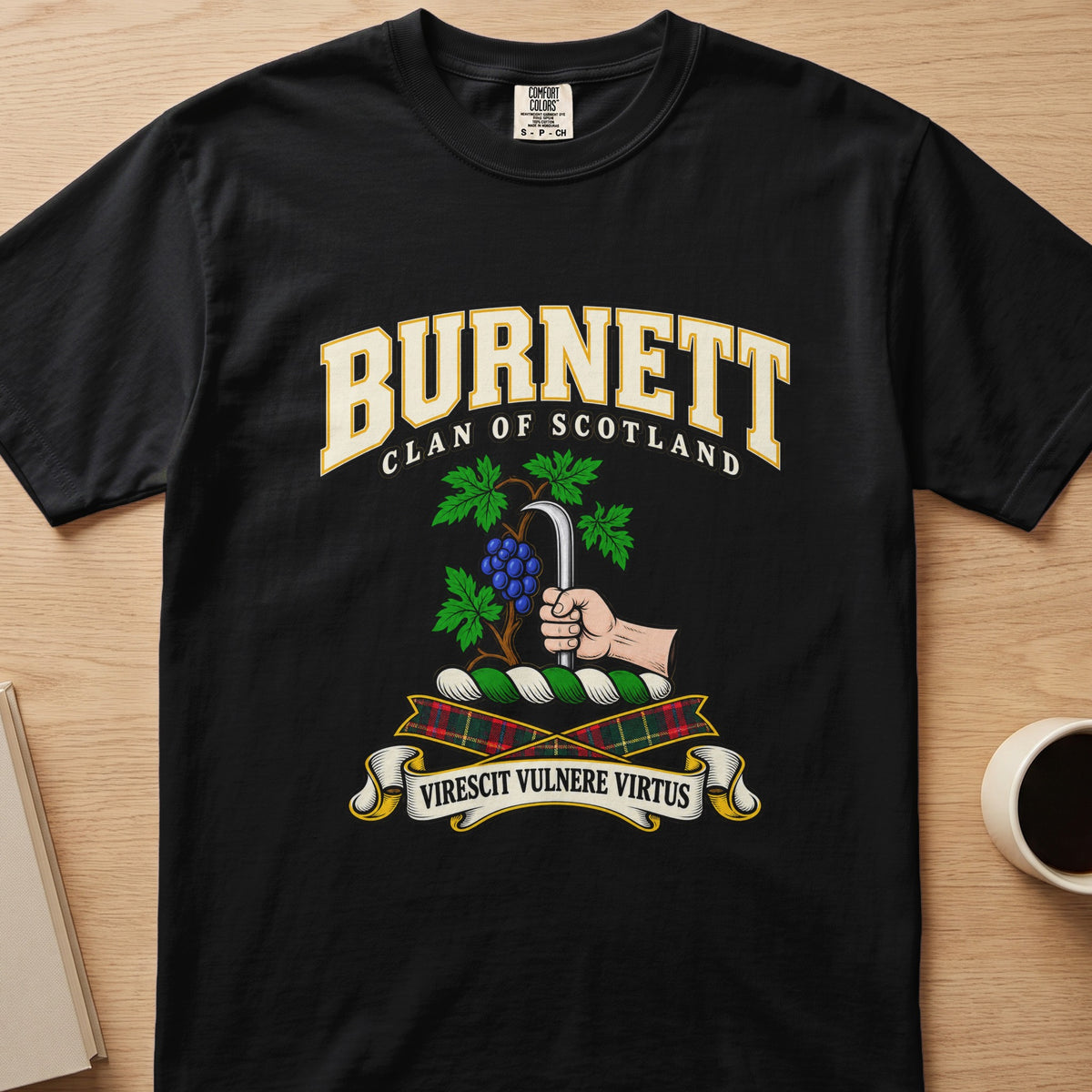 Burnett clan crest with grapevine and pruning hook on a black Comfort Colors T-shirt, front view