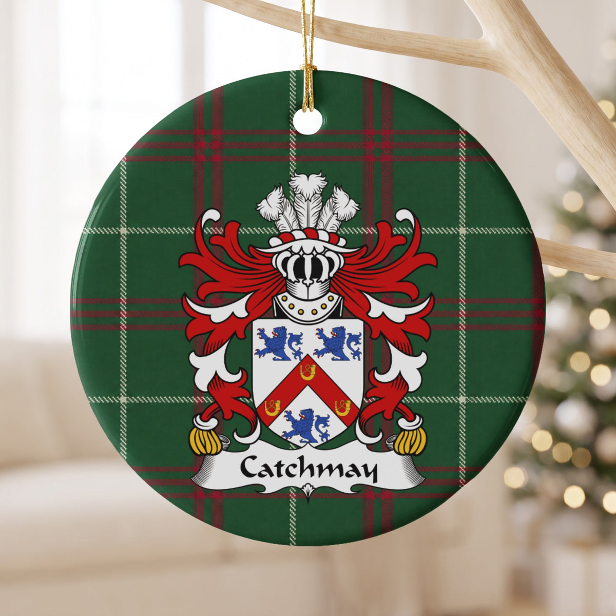 Catchmay ornament hanging from a pale wooden branch; a red chevron bearing three gold horseshoes between three blue lions on a white shield on Welsh national tartan.