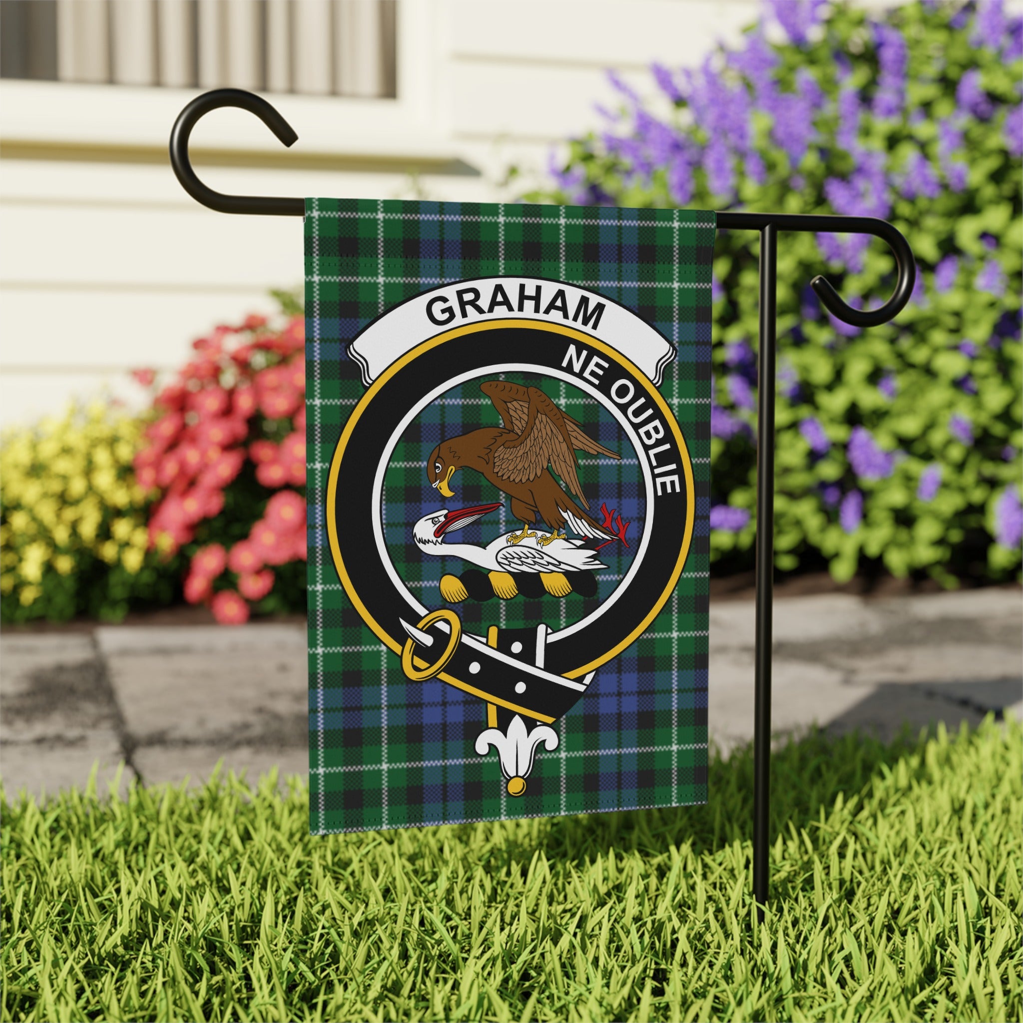 Graham clan crest with eagle on tartan garden flag — close-up
