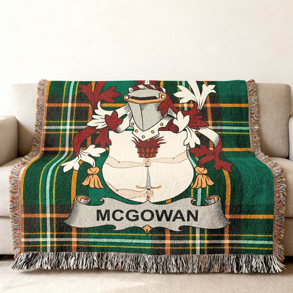 McGowan family crest on a green plaid throw blanket draped over a sofa.