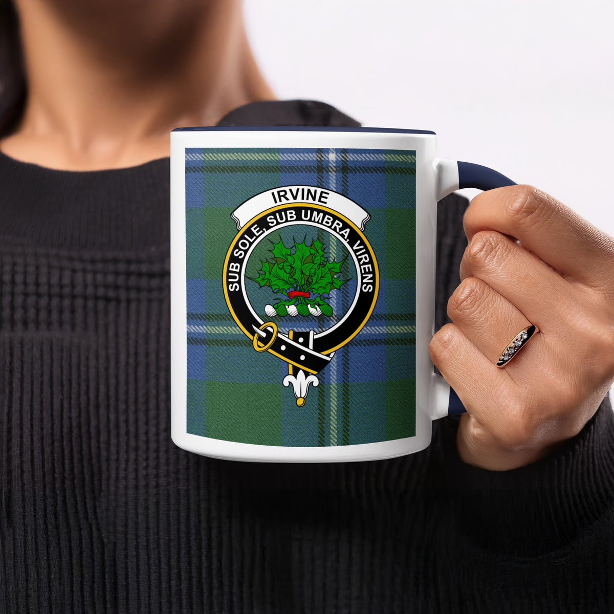 Close-up lifestyle view of Irvine Scottish clan crest artwork on a navy 11 oz accent mug with a tartan background