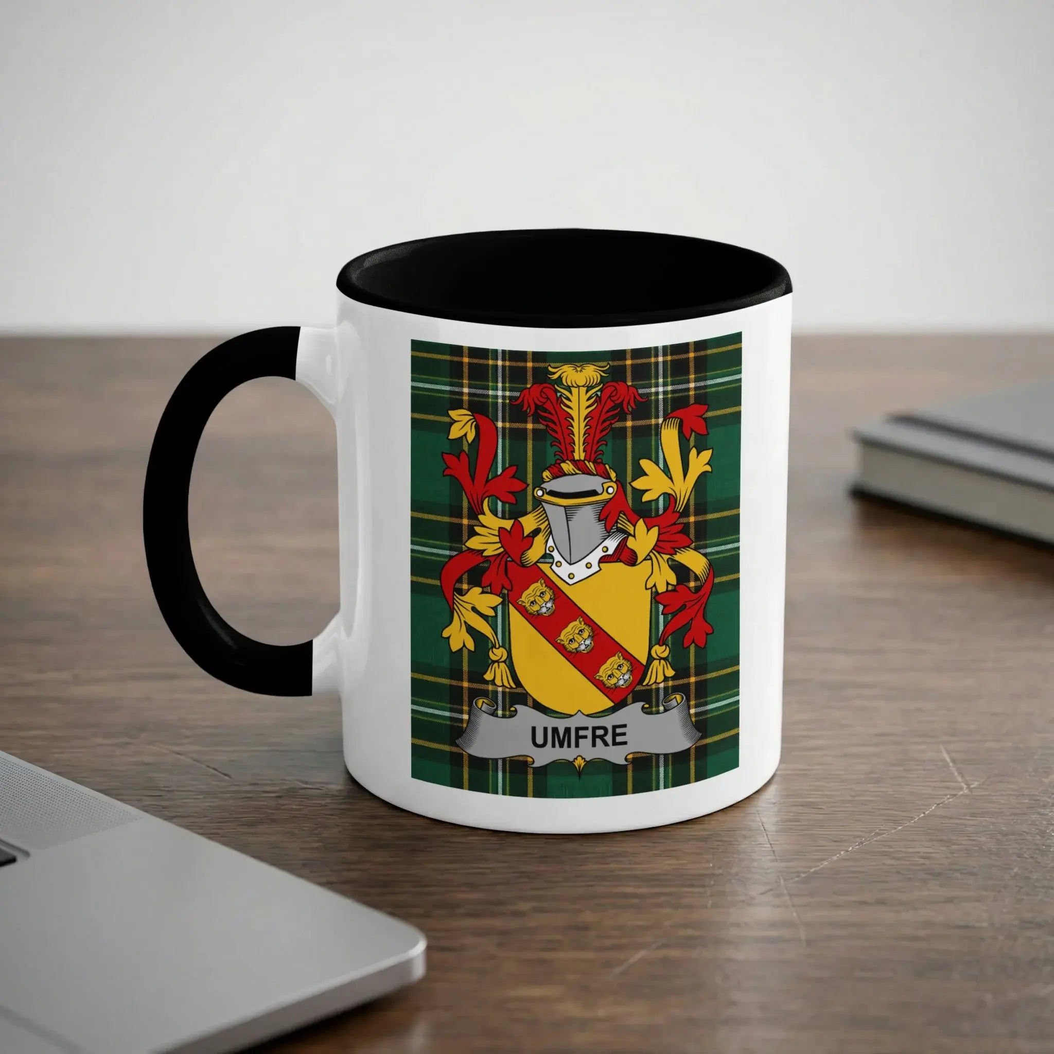 White mug with black rim, featuring a family crest with "UMFRE" text.