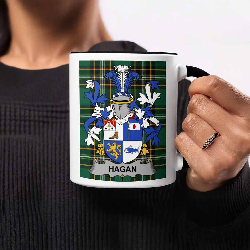 Hagan family crest on a plaid background on a black and white mug.