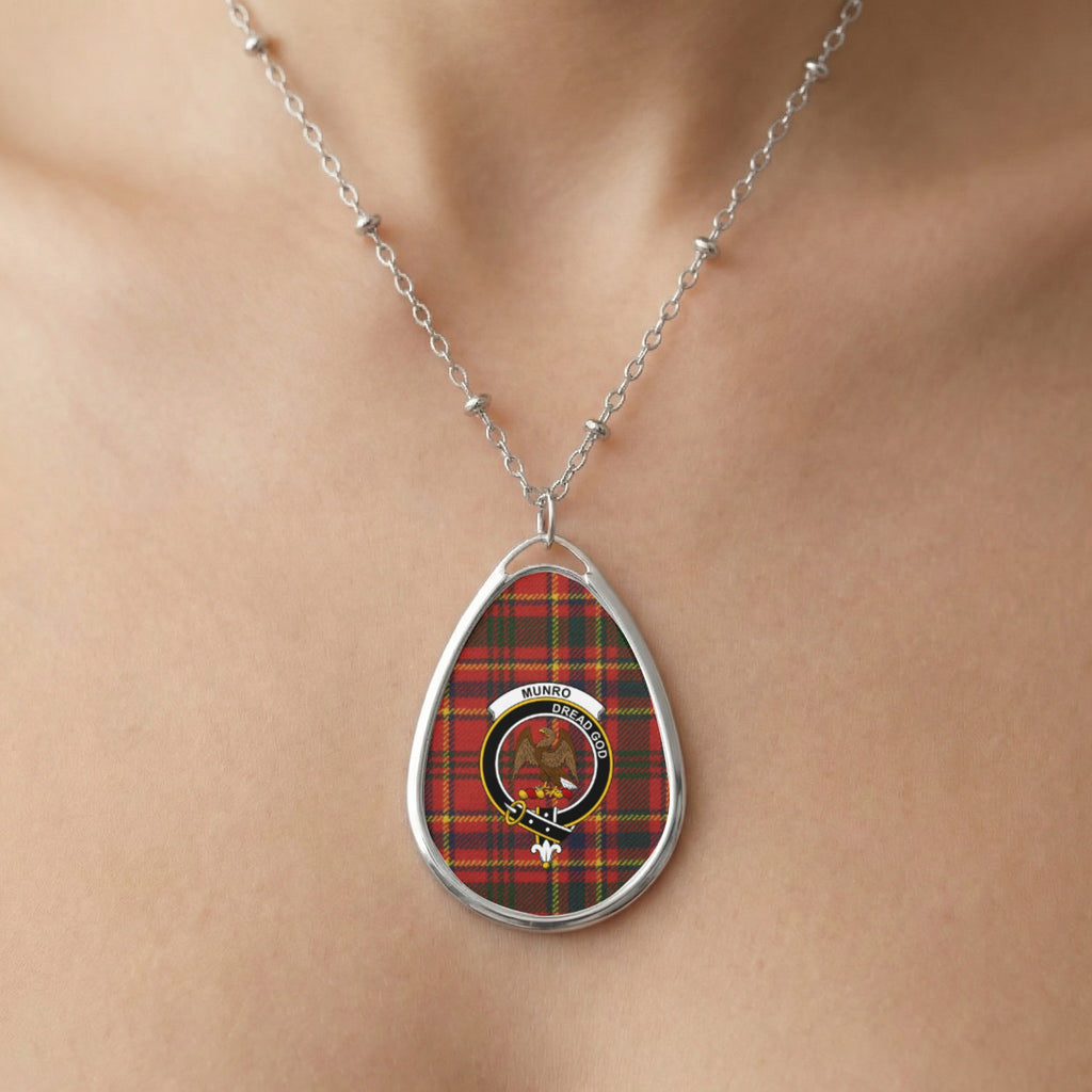 Oval pendant with Munro tartan and clan crest on silver chain necklace.