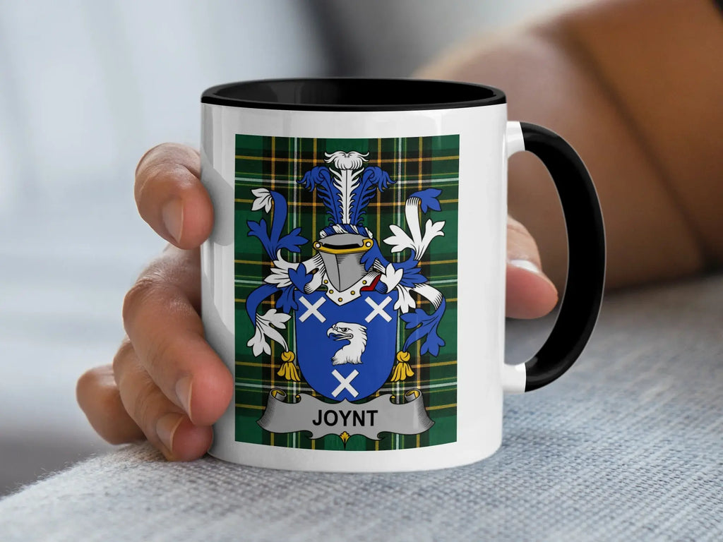 White mug with black handle featuring a blue and white family crest with "JOYNT" text.