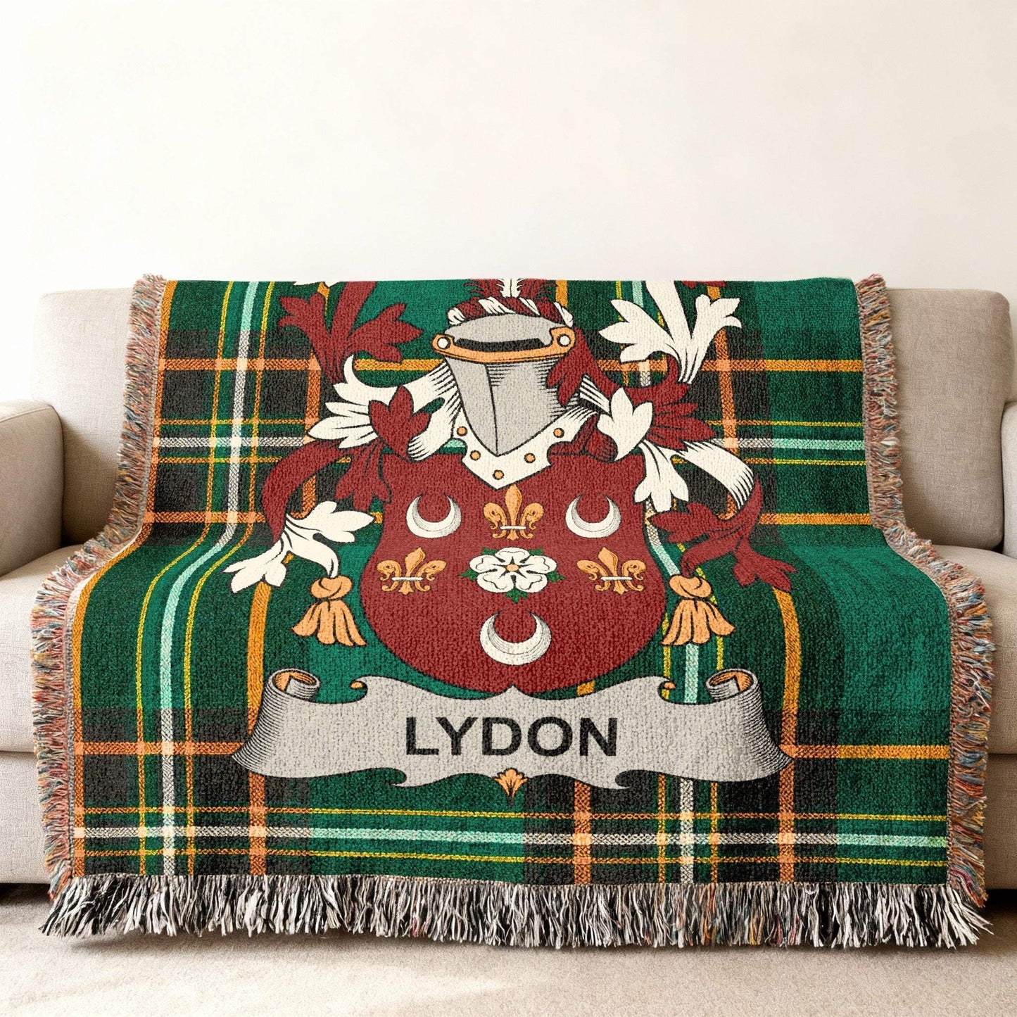 Tartan blanket featuring the Lydon family crest on a couch.