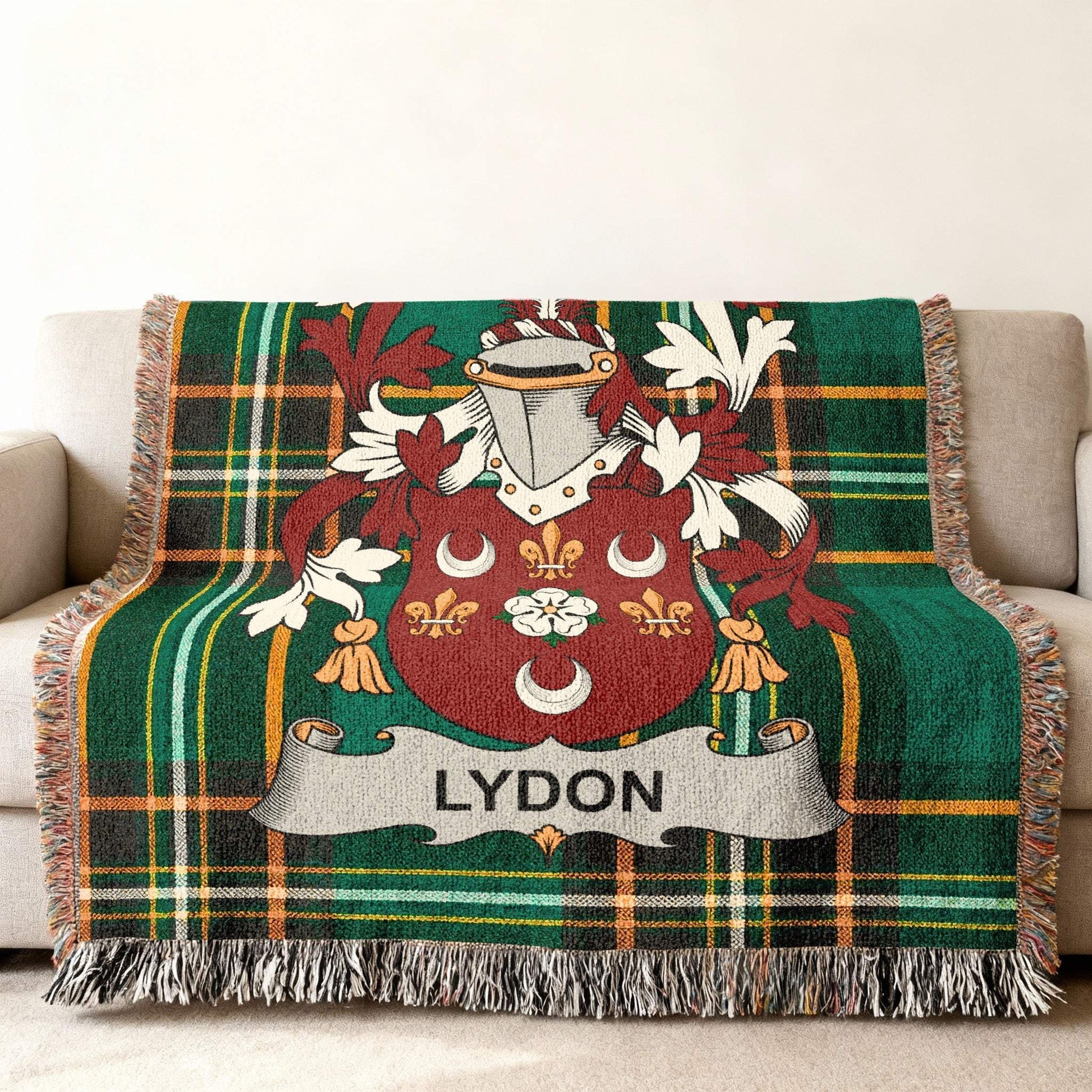 Tartan blanket featuring the Lydon family crest on a couch.