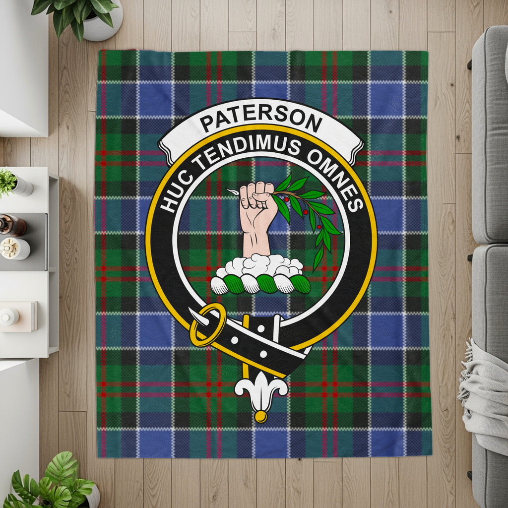 Paterson crest with fist and laurel on tartan printed throw — detail