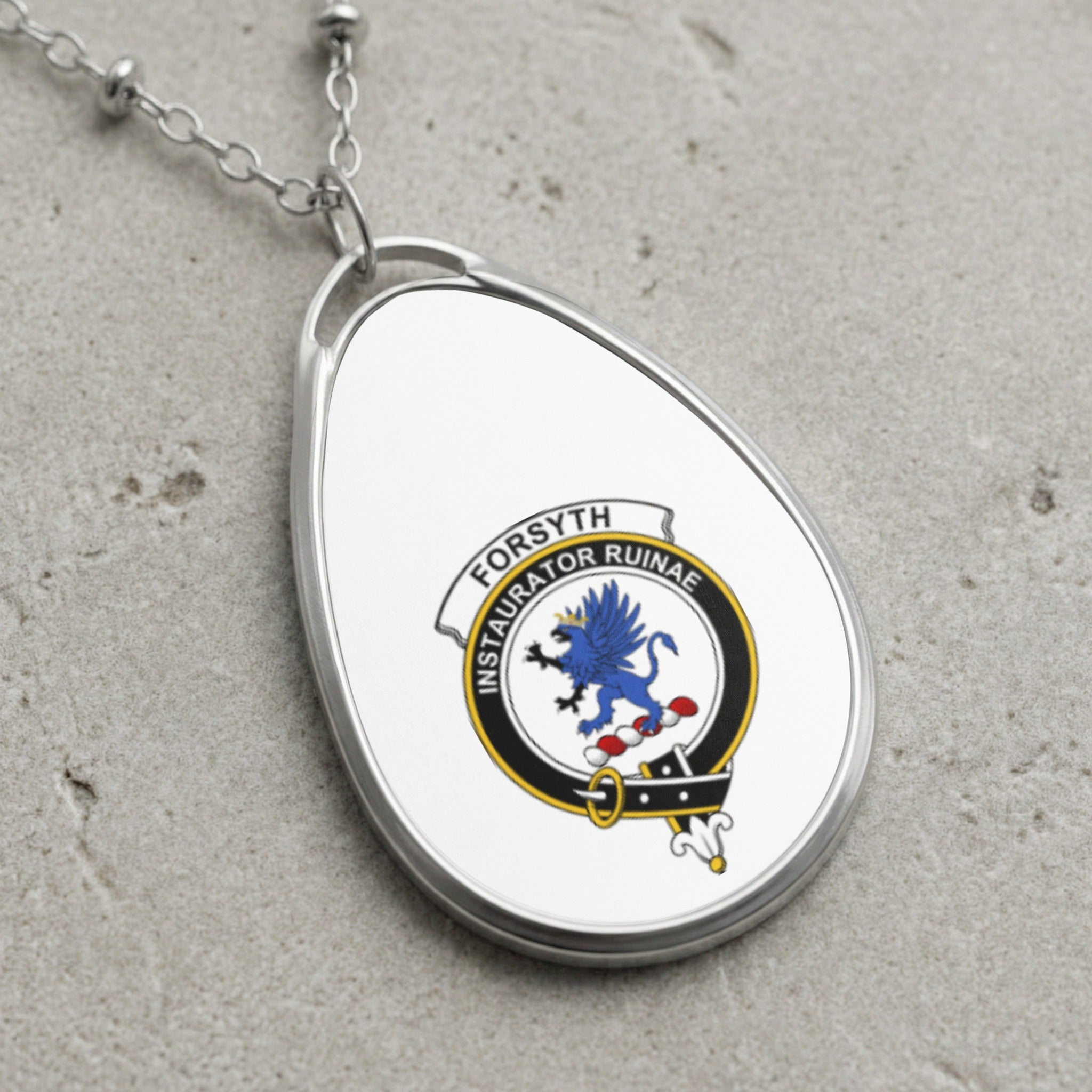 Oval pendant necklace with Forsyth clan crest and Latin motto.