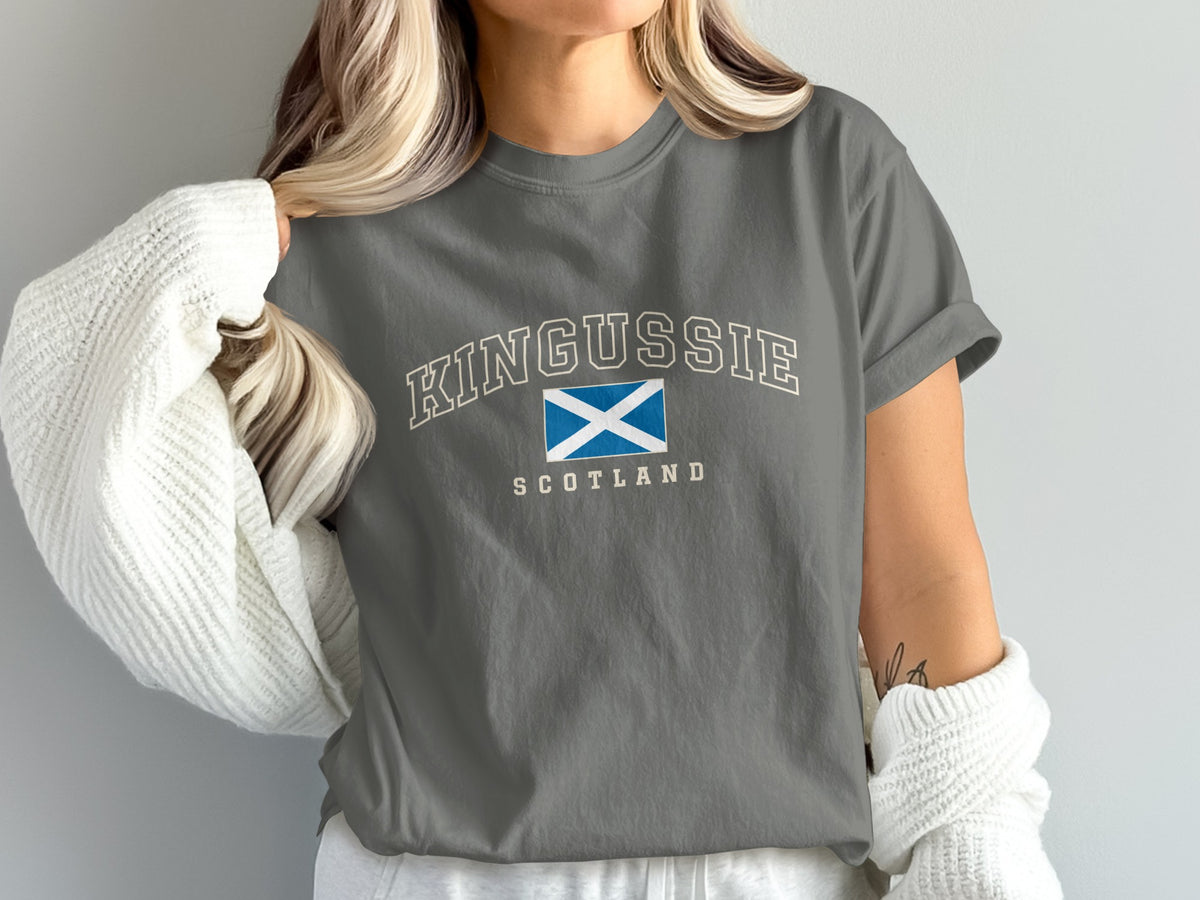 Model wearing the Pepper Kingussie Scotland Comfort Colors T-shirt with cream collegiate lettering
