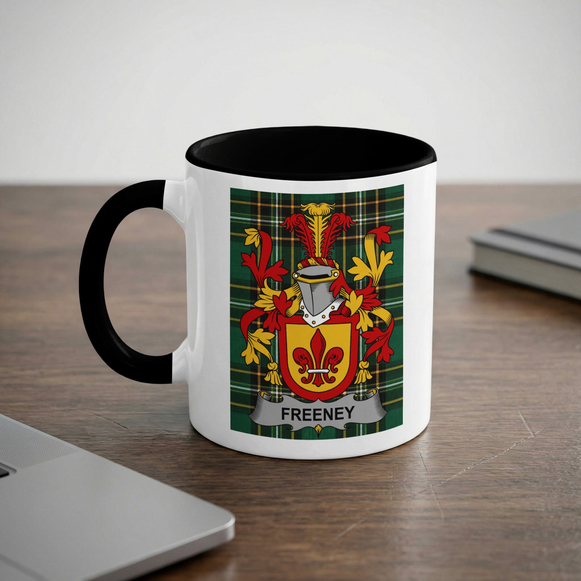 White mug with black rim and handle, featuring the Freeney family crest.