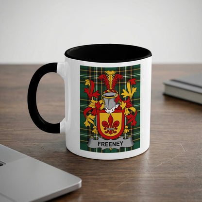 White mug with black rim and handle, featuring the Freeney family crest.