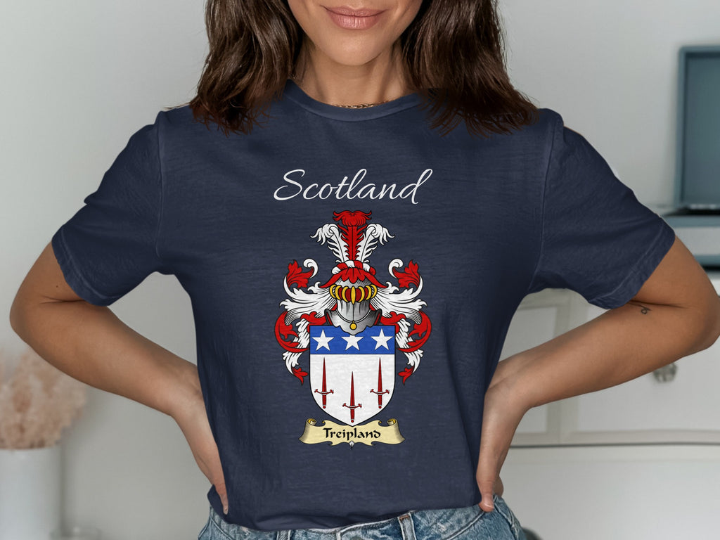 Model wearing the navy Treipland family crest T-shirt featuring “Scotland” and the surname banner.