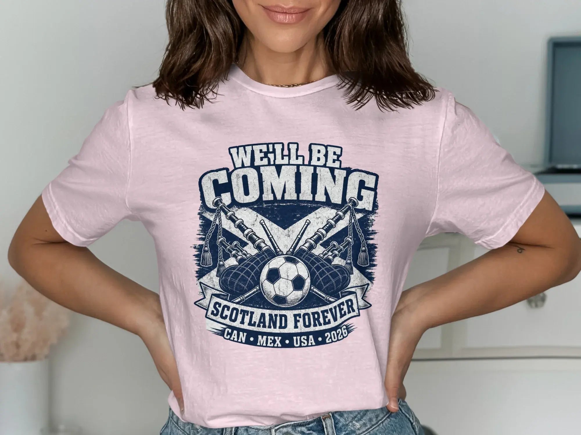 Pink t-shirt with "WE'LL BE COMING SCOTLAND FOREVER" and bagpipes graphic.