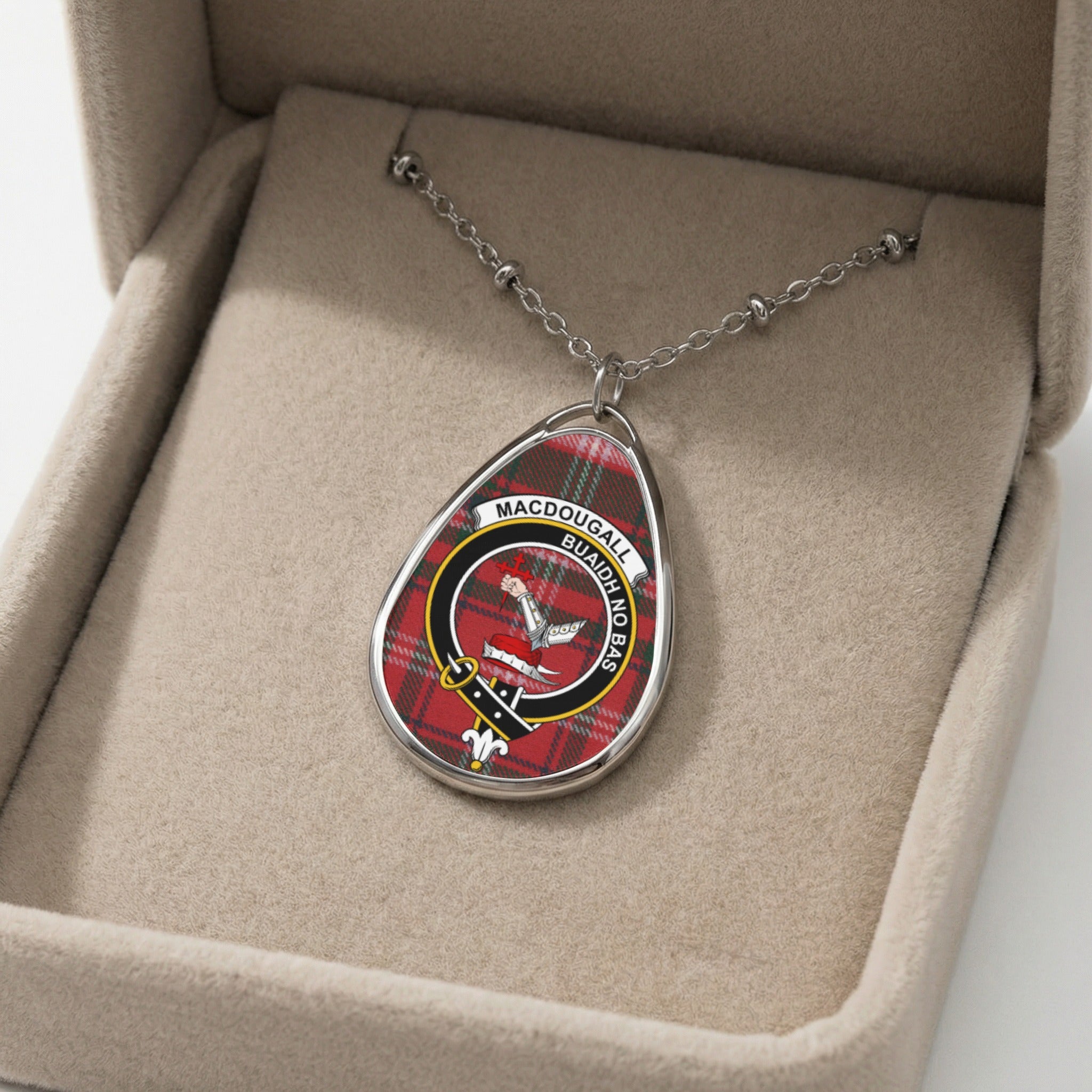 Oval MacDougall clan crest pendant necklace with tartan in a jewelry box.