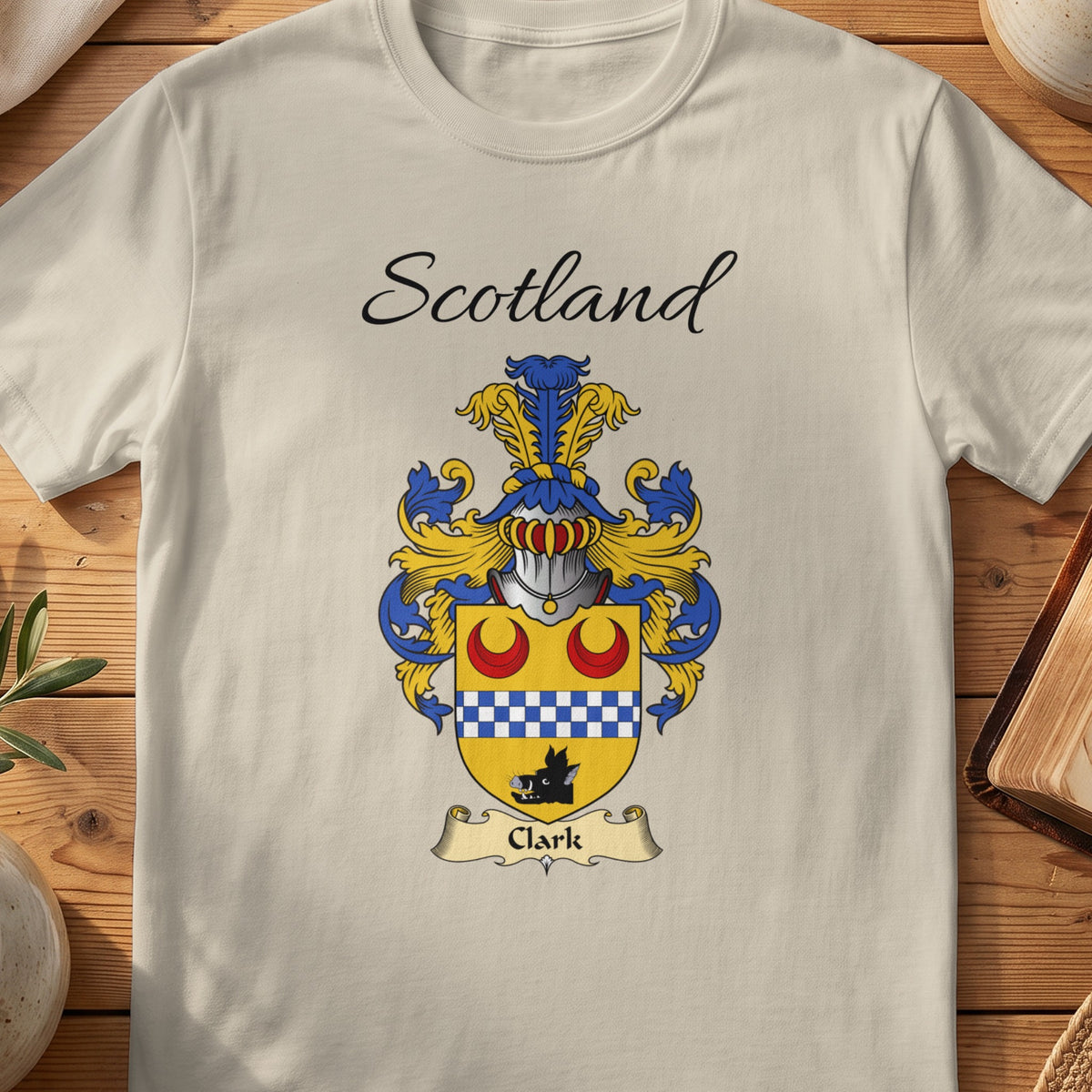 Sand Clark Scottish family shield T-shirt featuring red crescents above a blue-and-white checked band