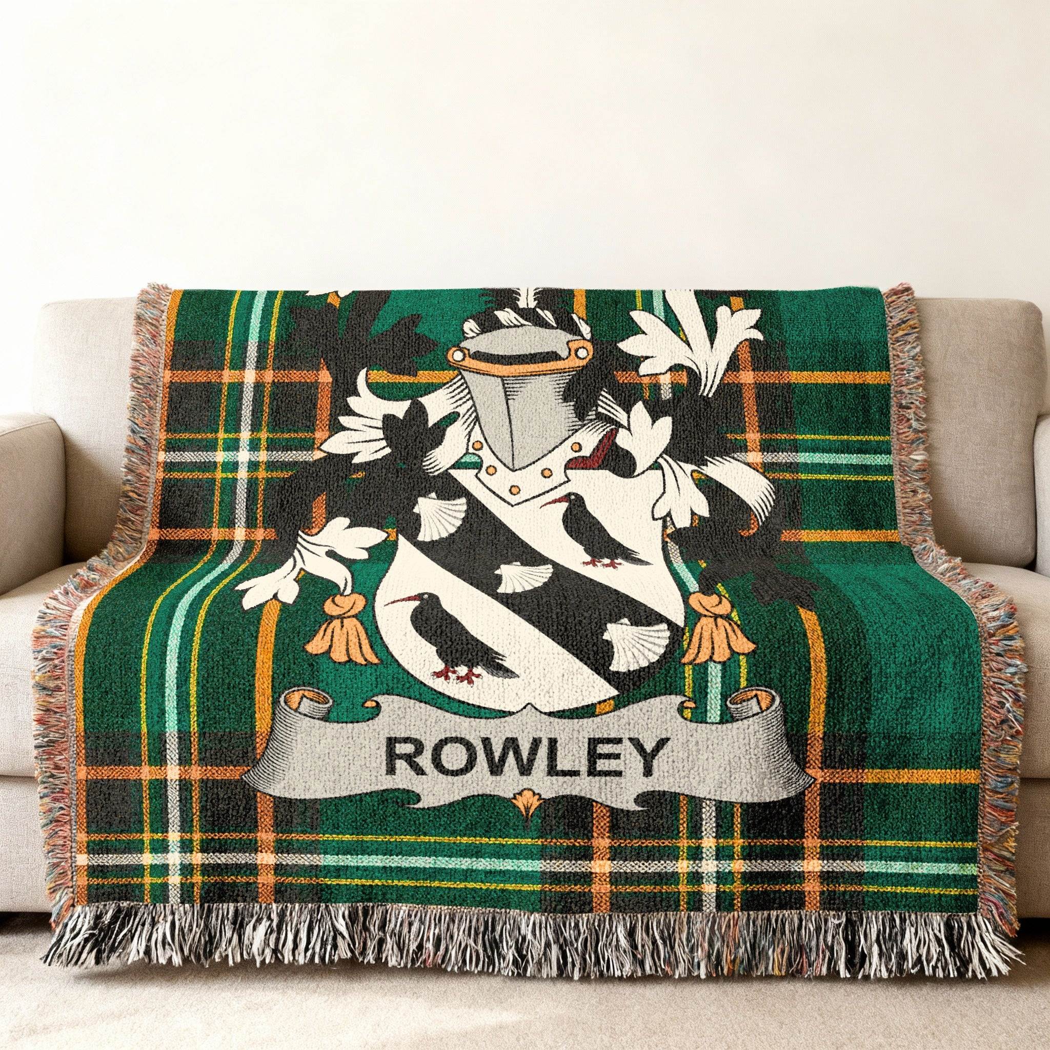 Rowley family crest on a green plaid woven throw blanket draped on a sofa.