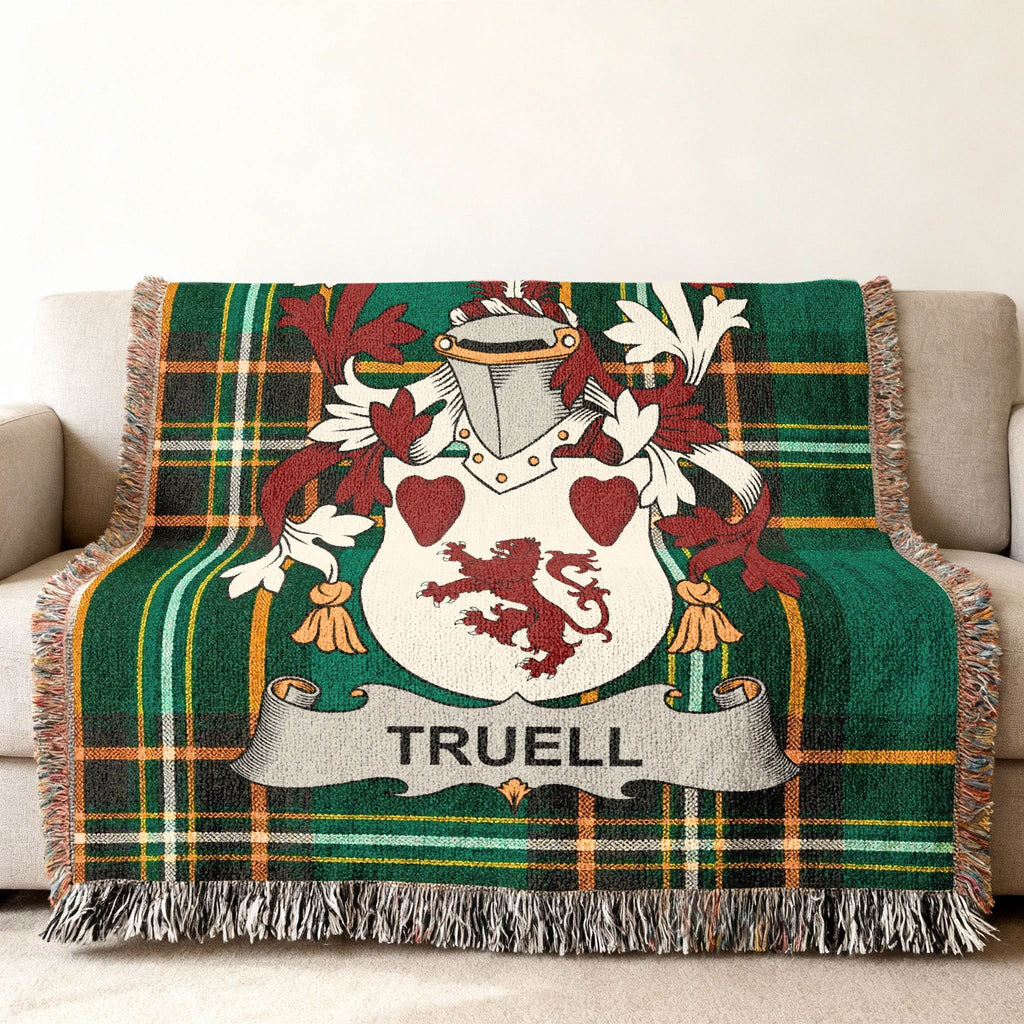 Green tartan throw blanket with Truell family crest.