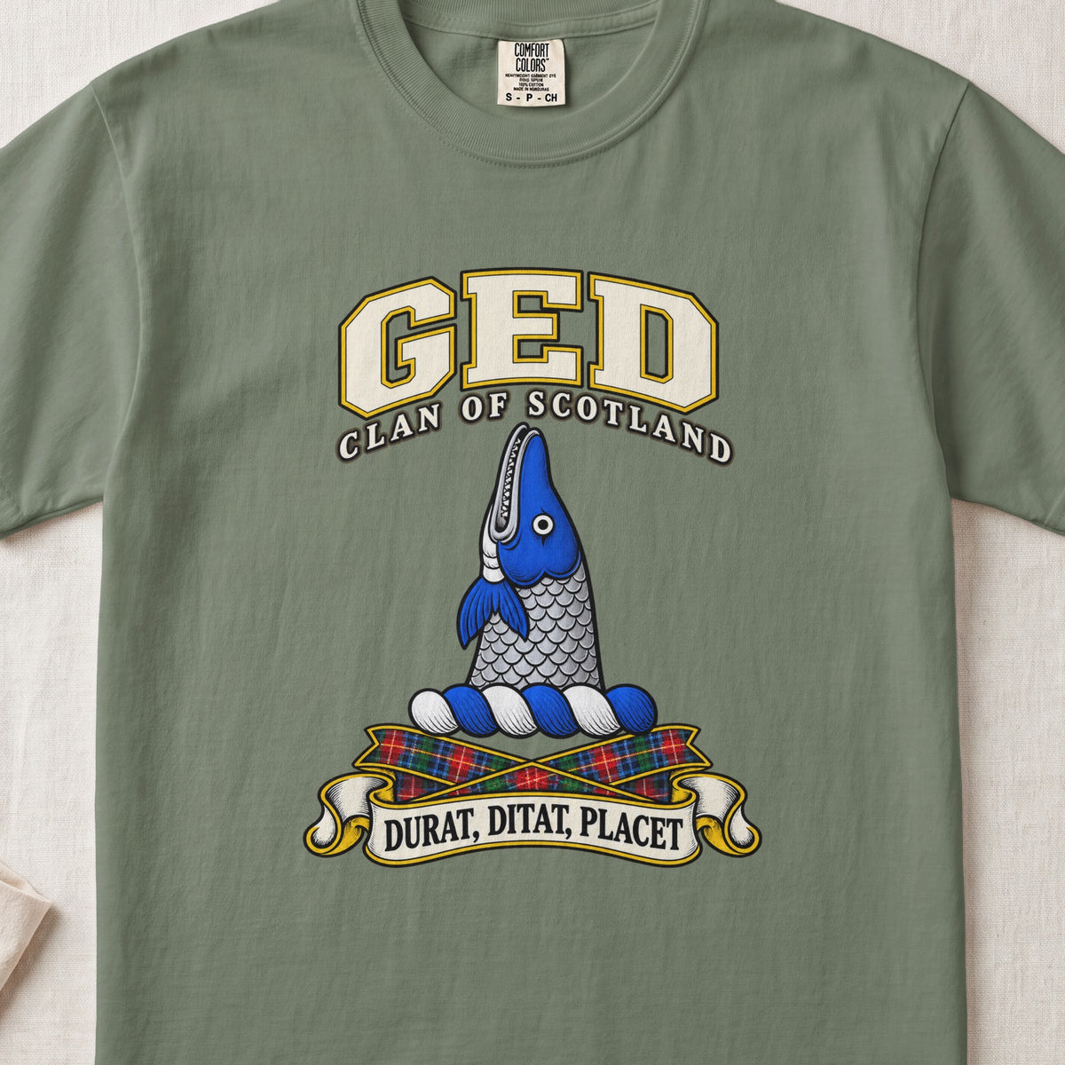 Ged Scottish clan T-shirt in Moss, front view with an upright blue-and-silver fish and motto banner.