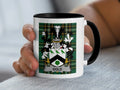 Mug with black rim featuring a green and black tartan and the surname "Gold."